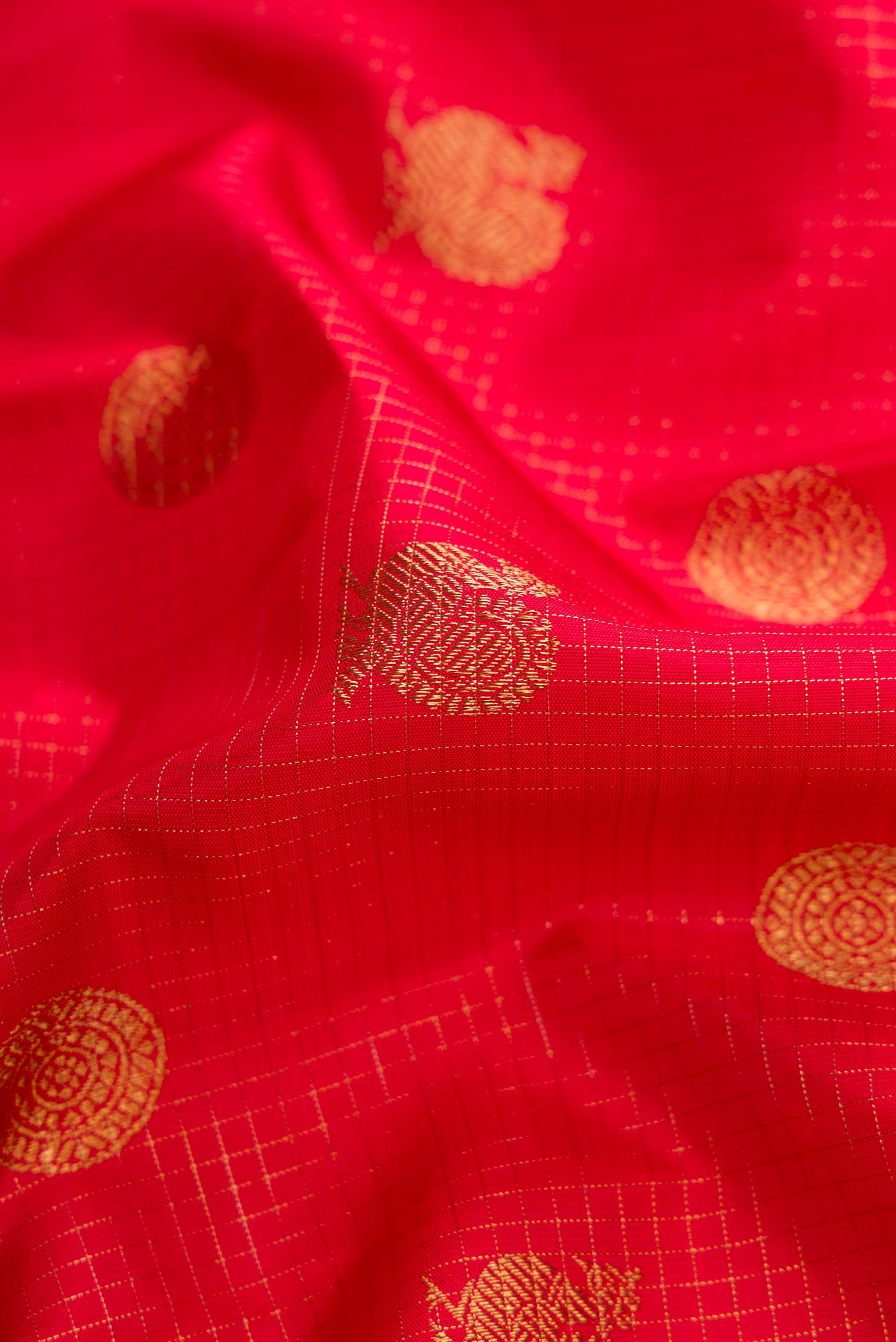 Close up of Pure Silk Pure Zari Dark Pink Dual Tone Kanjivaram Saree with Zari Butta on the body and Zari Border.  displaying folds