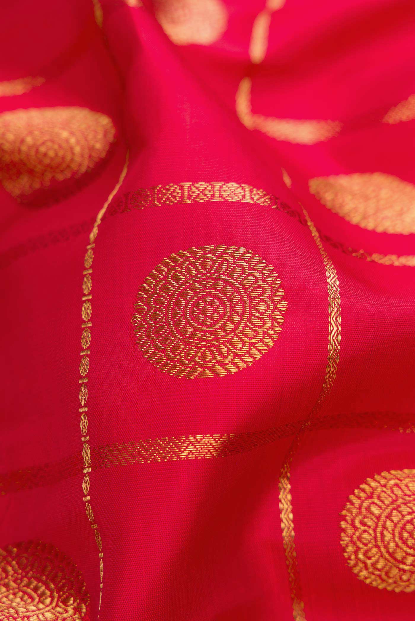 Close up of Pure Silk Pure Zari Red Dual Tone Kanjivaram Saree with Checked design on the body and Zari Border.  displaying folds