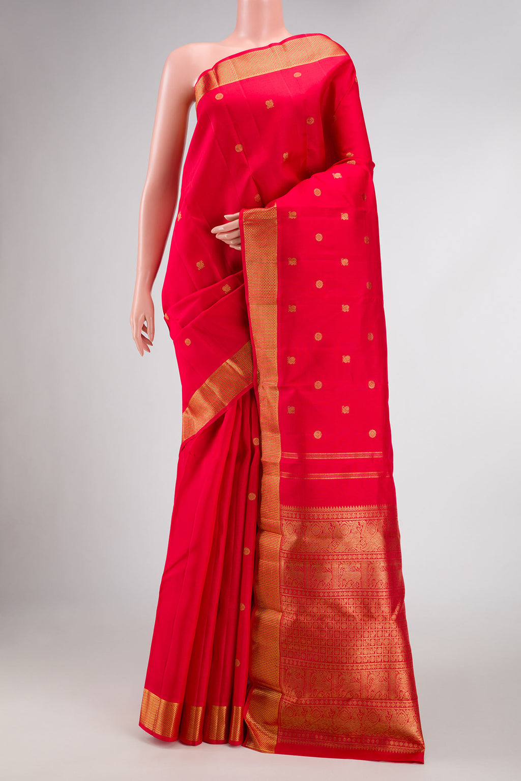 Pure Silk Pure Zari Red Dual Tone Kanchipuram Saree with Zari Butta on the body and Zari Border.  displayed on a mannequin