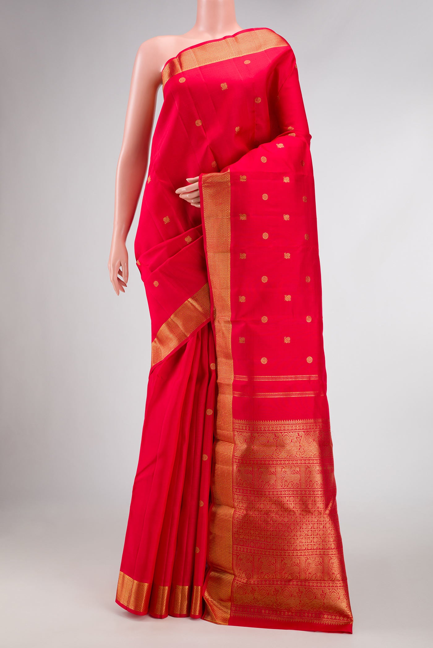 Pure Silk Pure Zari Red Dual Tone Kanchipuram Saree with Zari Butta on the body and Zari Border.  displayed on a mannequin