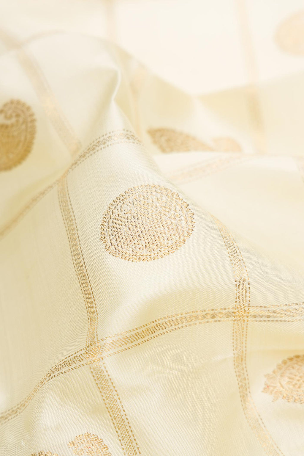Close up of Pure Silk Pure Zari Sandal Dual Tone Kanchipuram Saree with Checked design on the body and Zari Border displaying folds
