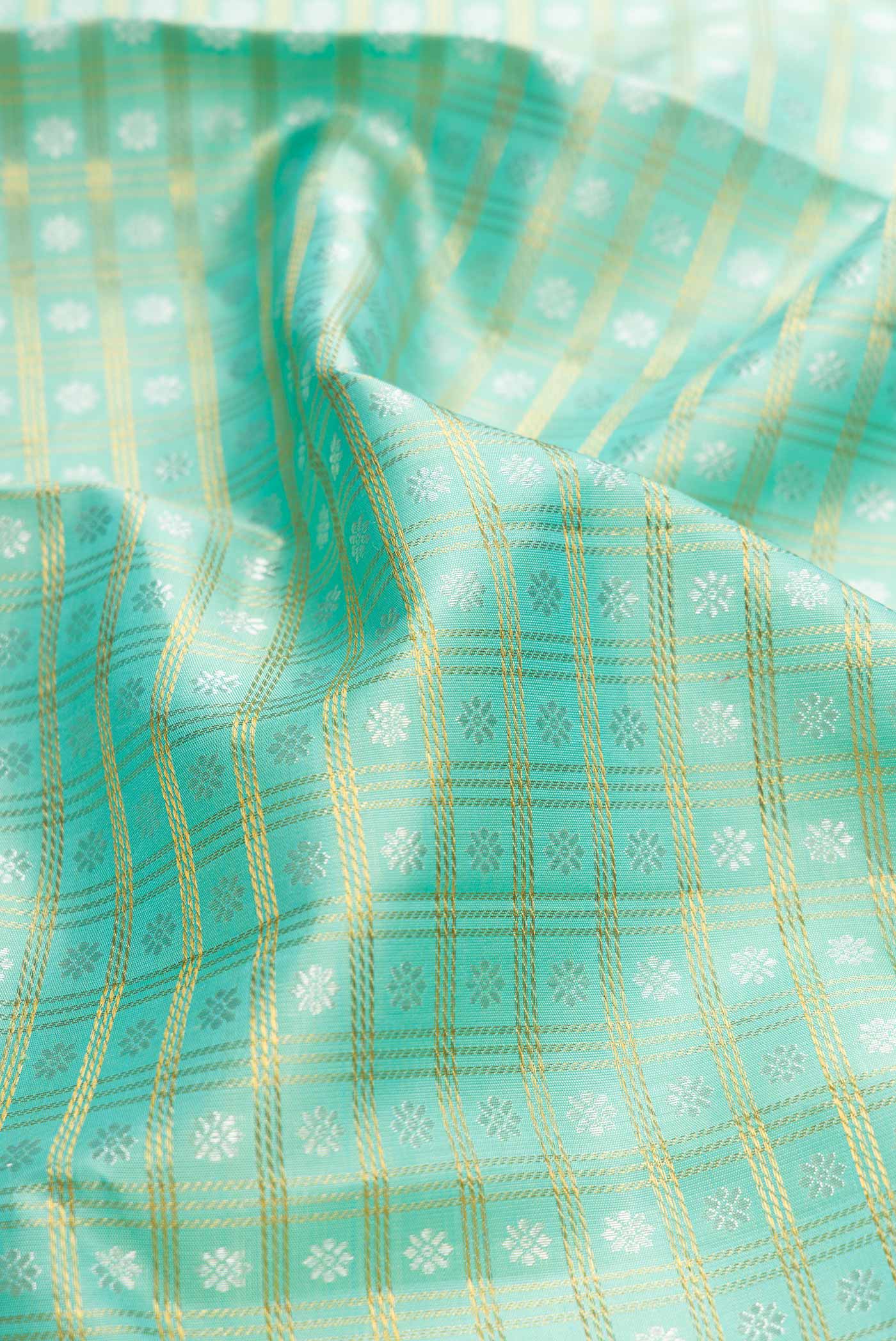 Close up of Pure Silk Pure Zari Sea Green Dual Tone Kanchipuram Saree with Zari Brocade on the body and Zari Border displaying folds