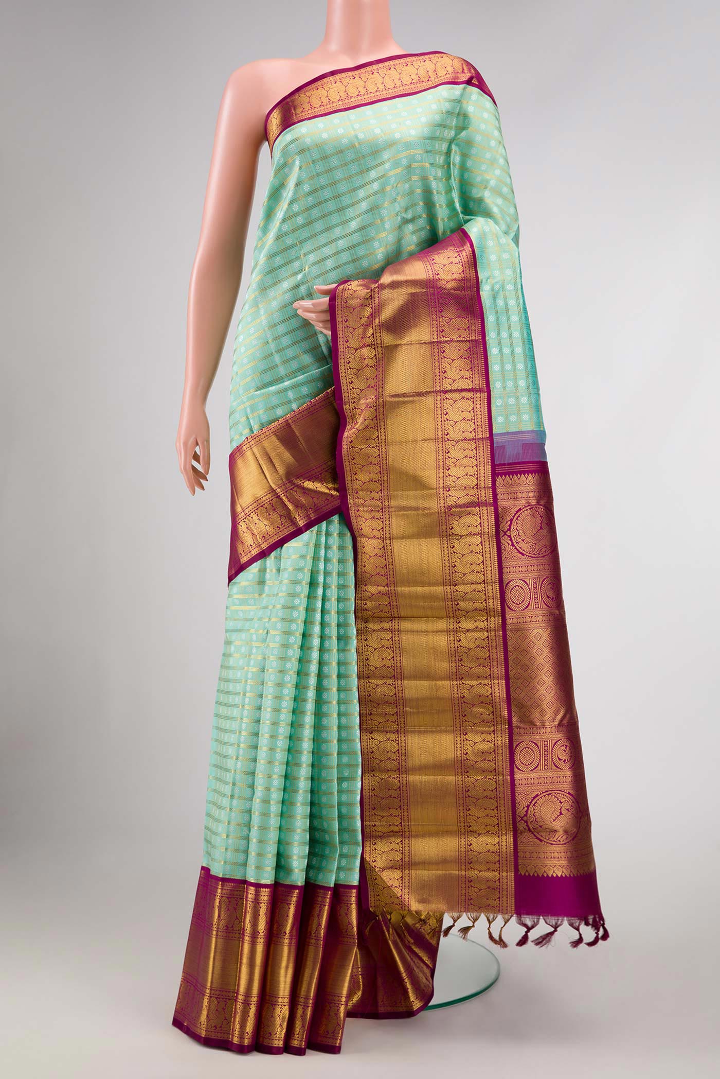 Pure Silk Pure Zari Sea Green Dual Tone Kanchipuram Saree with Zari Brocade on the body and Zari Border displayed on a mannequin