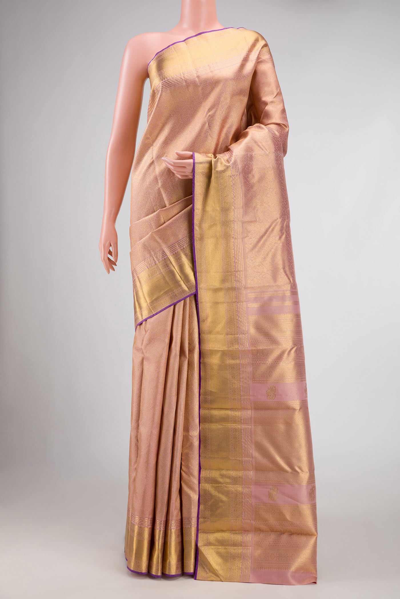 Pure Silk Pure Zari Rose Gold Kanchipuram Saree with Zari Brocade on the body and Zari Border displayed on a mannequin
