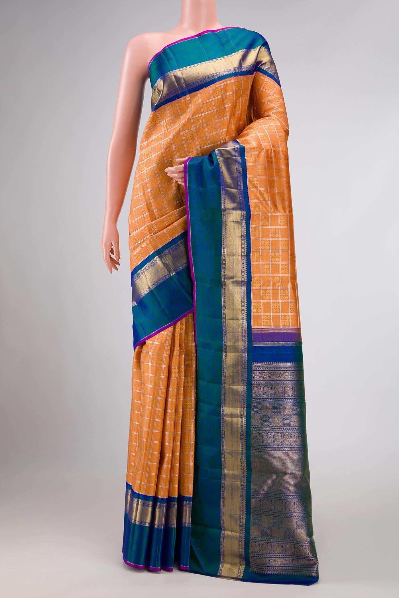 Pure Silk Pure Zari Orange Dual Tone Kanchipuram Saree with Zari Brocade on the body and Zari Border displayed on a mannequin