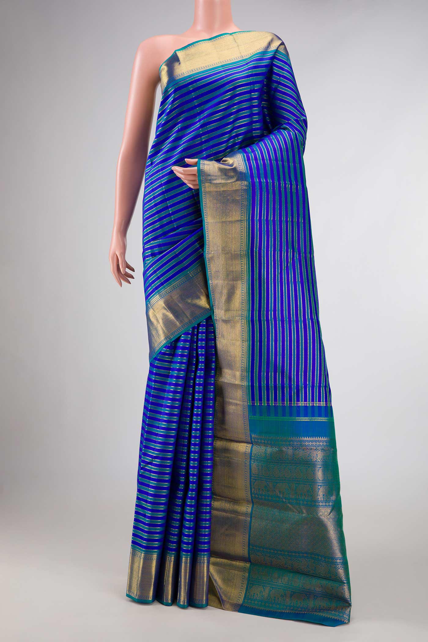 Pure Silk Pure Zari Royal Blue Dual Tone Kanchipuram Saree with Stripes on the body and Zari Border displayed on a mannequin