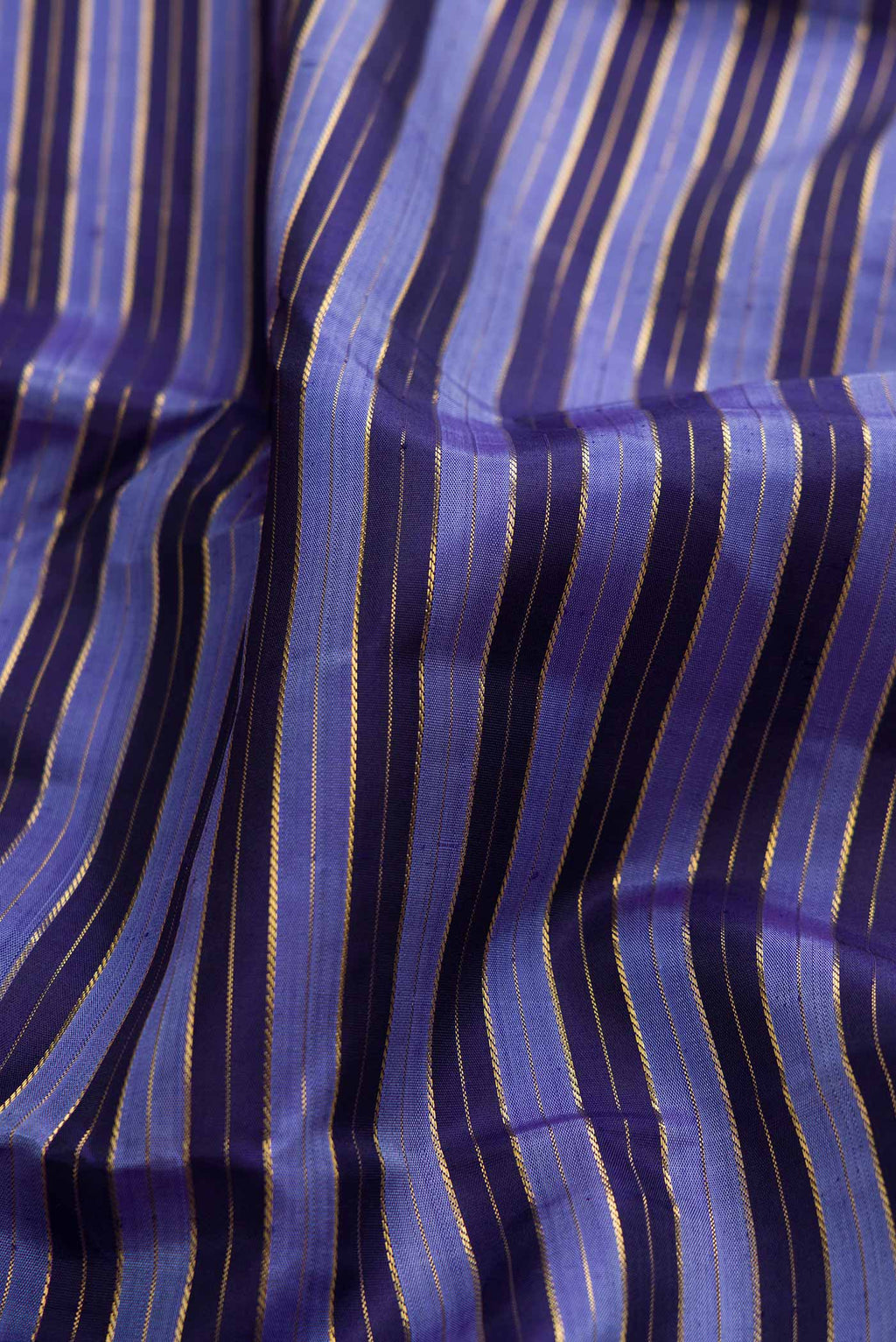 Close up of Pure Silk Pure Zari Blue Dual Tone Kanchipuram Saree with Stripes on the body and Zari Border displaying folds