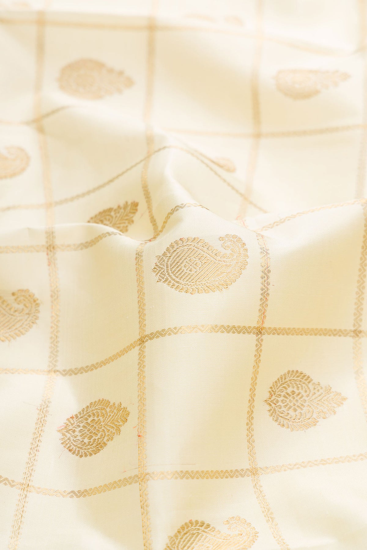 Close up of Pure Silk Pure Zari Sandal Dual Tone Kanchipuram Saree with Checked design on the body and Zari Border displaying folds