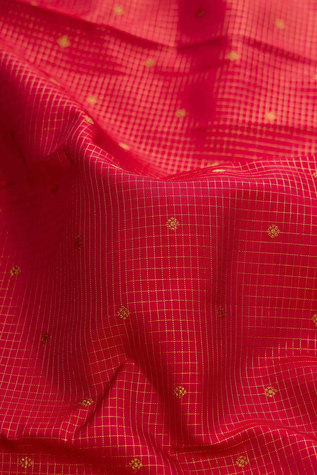 Close up of Pure Silk Pure Zari Maroon Dual Tone Kanchipuram Saree with Checked design on the body and Zari Border displaying folds