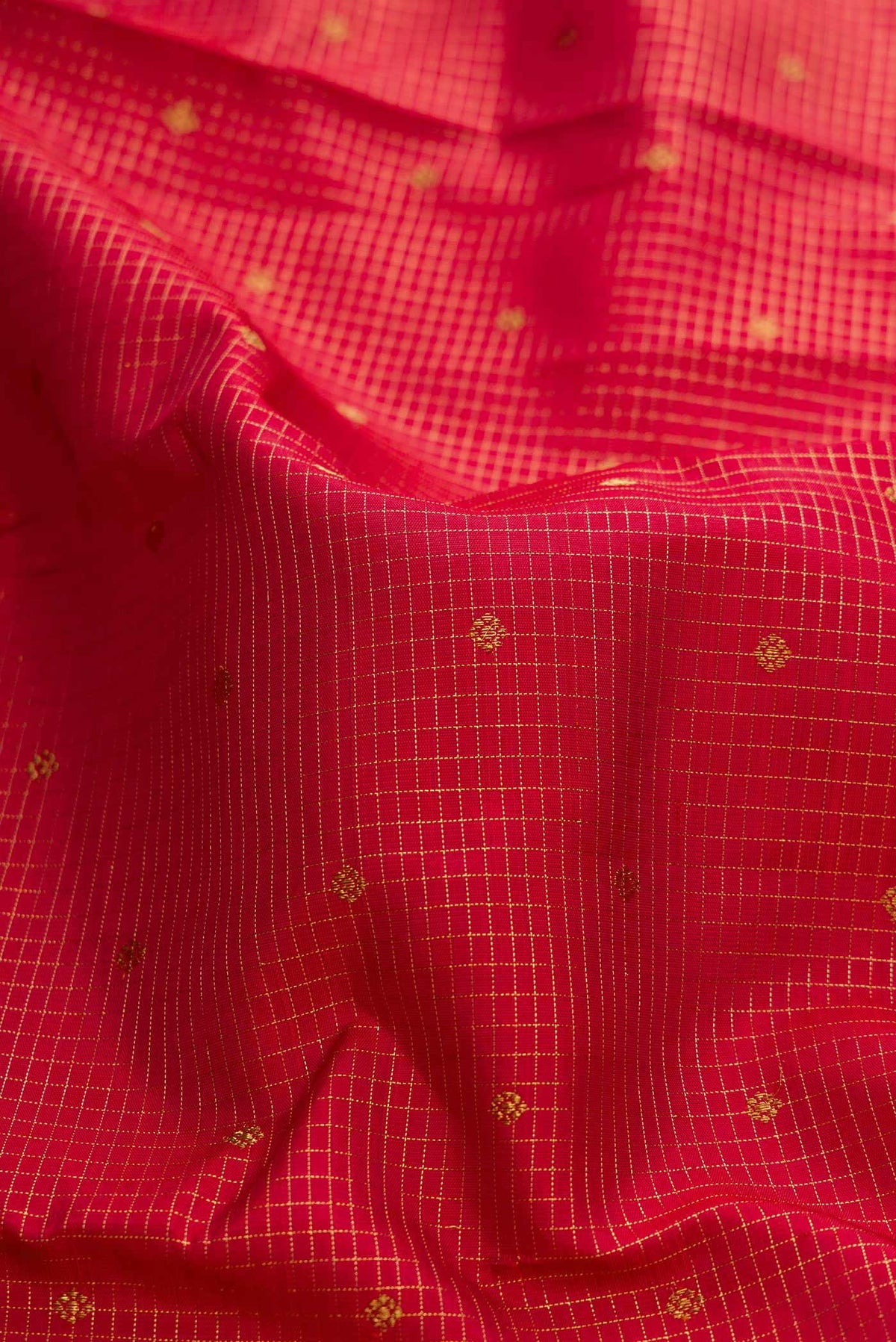 Close up of Pure Silk Pure Zari Maroon Dual Tone Kanchipuram Saree with Checked design on the body and Zari Border displaying folds
