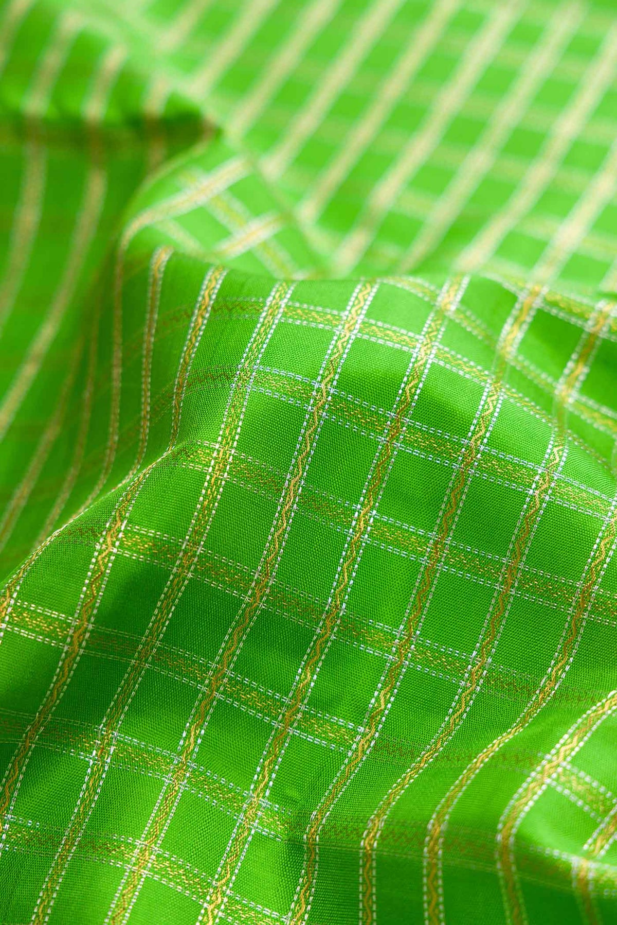 Close up of Pure Silk Pure Zari Parrot Green Dual Tone Kanchipuram Saree with Checked design on the body and Zari Border displaying folds