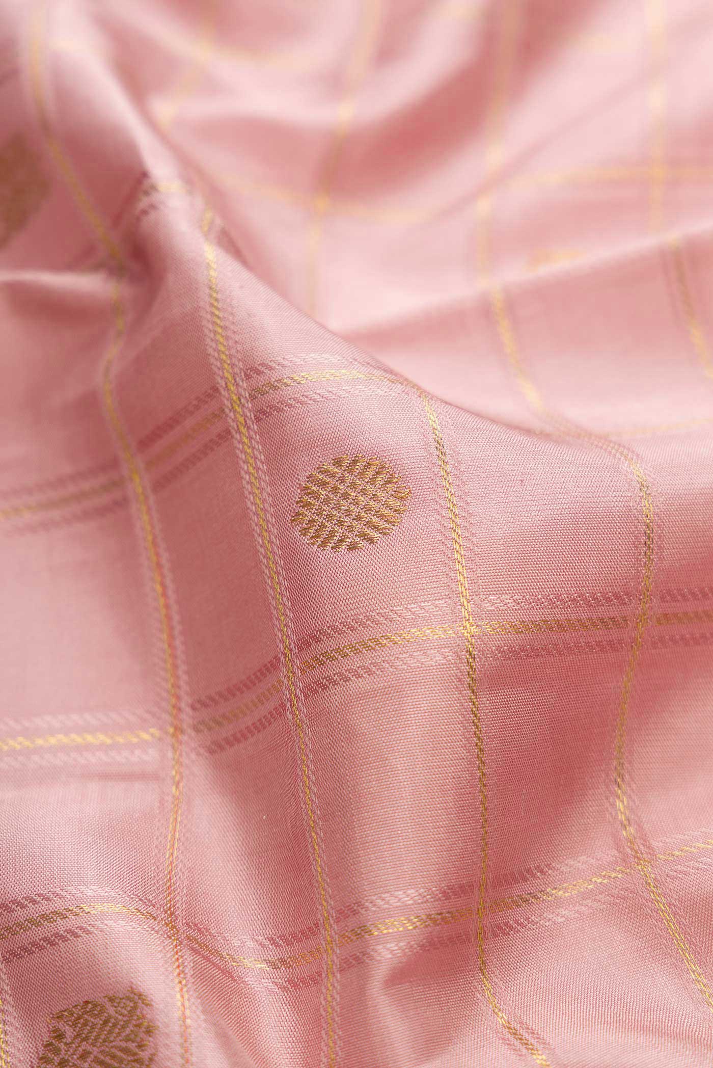 Close up of Pure Silk Pure Zari Rose Gold Dual Tone Kanchipuram Saree with Checked design on the body and Zari Border displaying folds