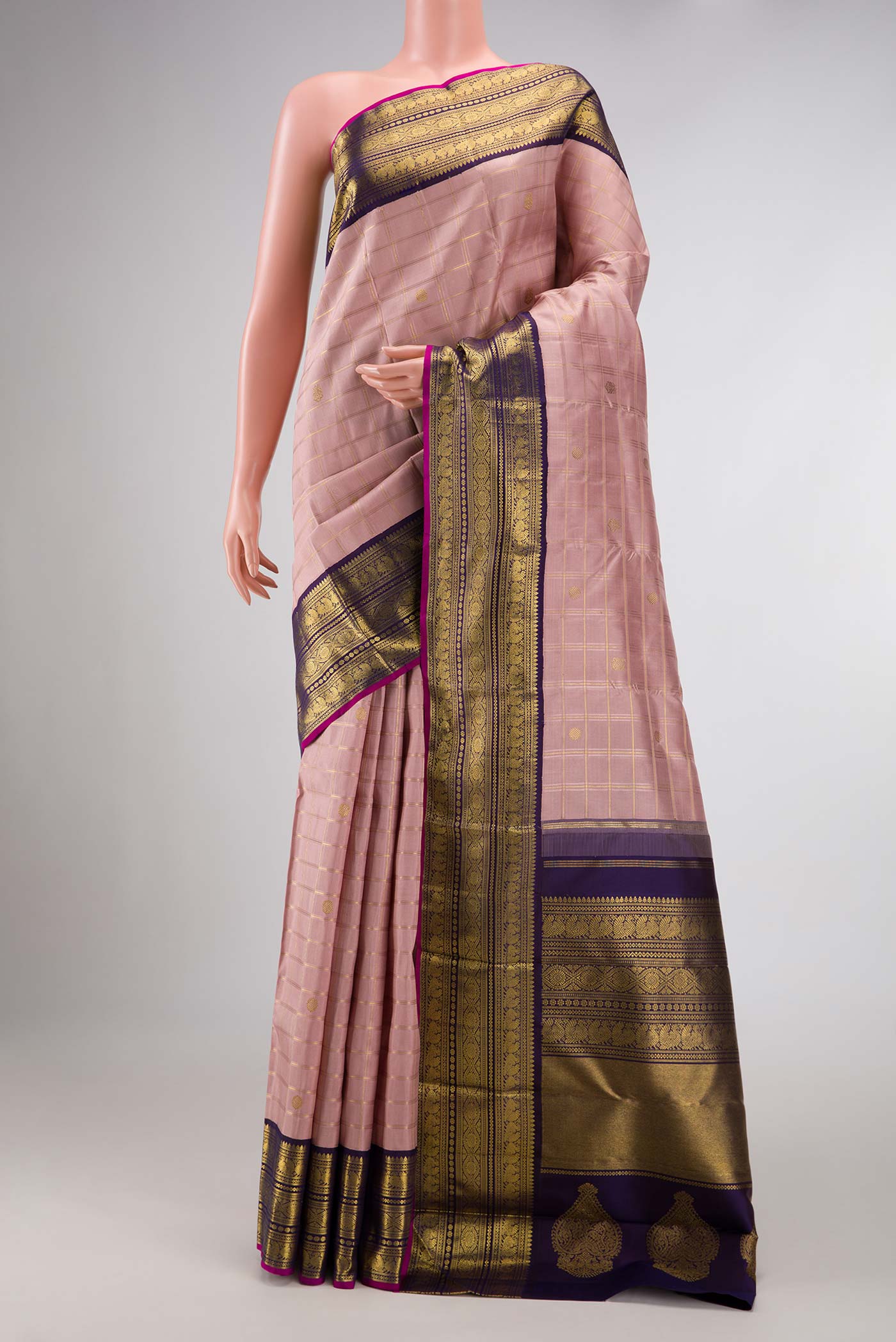 Pure Silk Pure Zari Rose Gold Dual Tone Kanchipuram Saree with Checked design on the body and Zari Border displayed on a mannequin