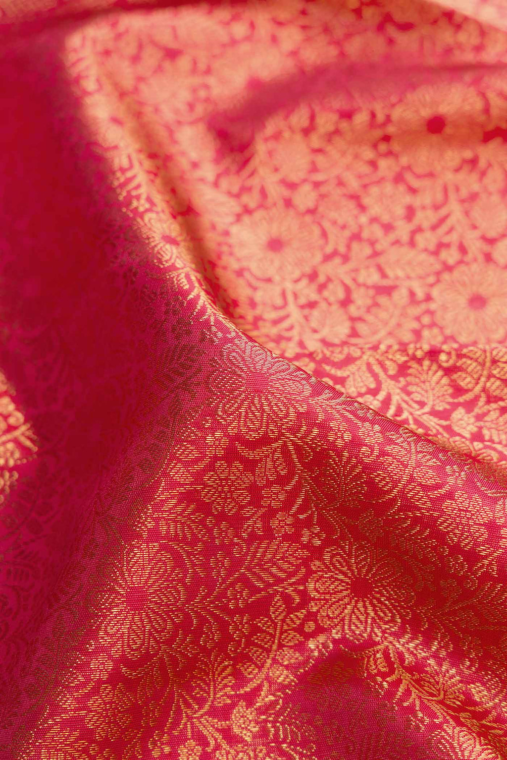 Close up of Pure Silk Pure Zari Pink Kanchipuram Saree with Zari Brocade on the body and Zari Border displaying folds
