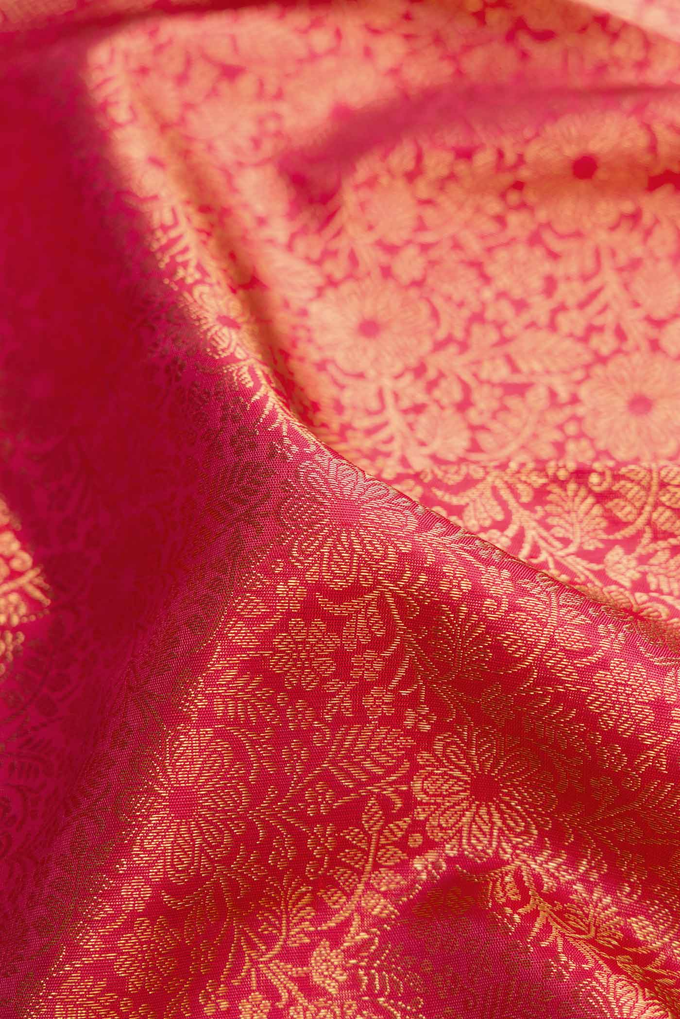 Close up of Pure Silk Pure Zari Pink Kanchipuram Saree with Zari Brocade on the body and Zari Border displaying folds