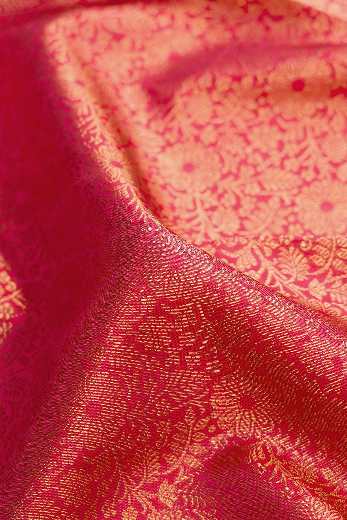 Close up of Pure Silk Pure Zari Pink Kanchipuram Saree with Zari Brocade on the body and Zari Border displaying folds