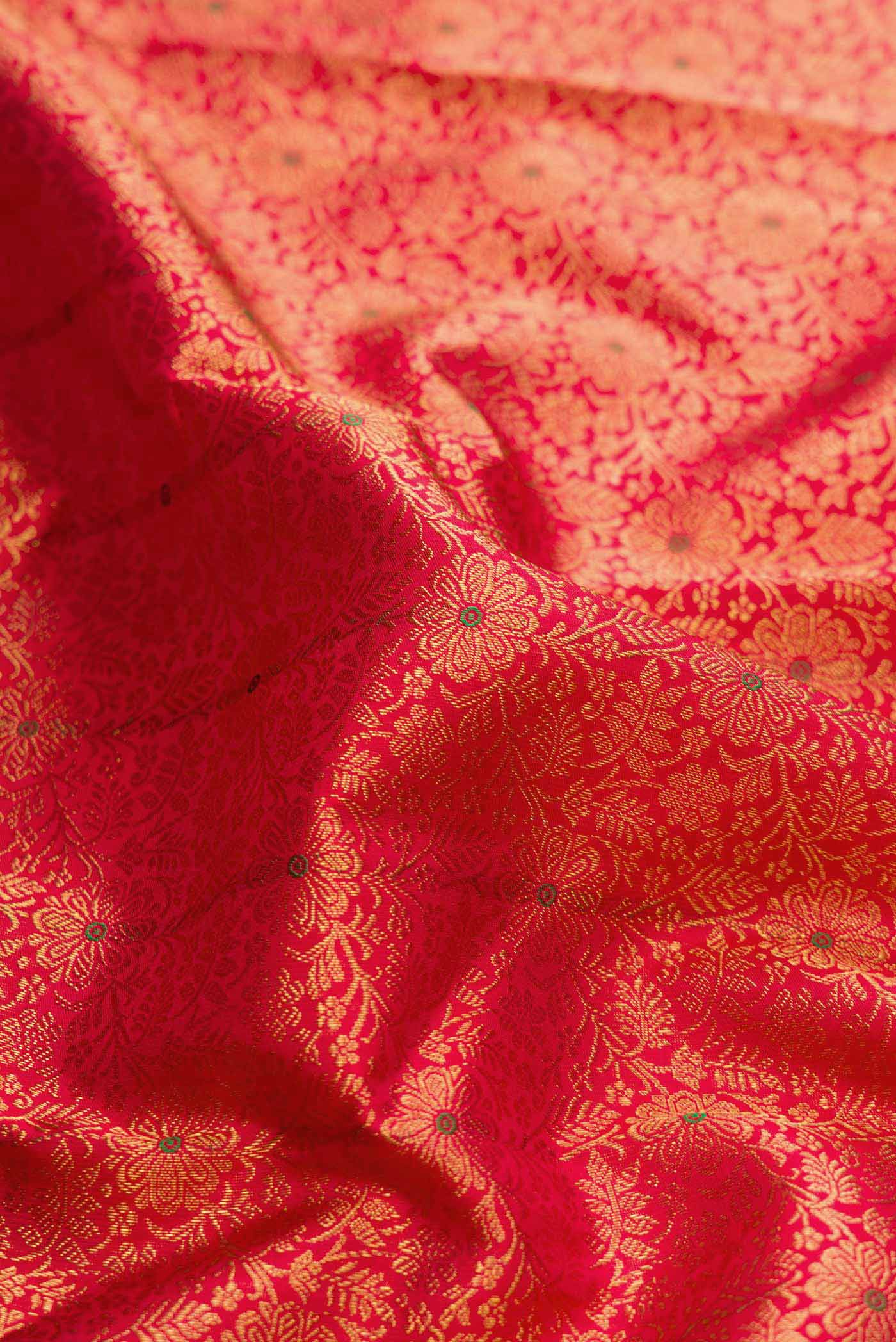 Close up of Pure Silk Pure Zari Red Dual Tone Kanchipuram Saree with Zari Brocade on the body and Zari Border displaying folds