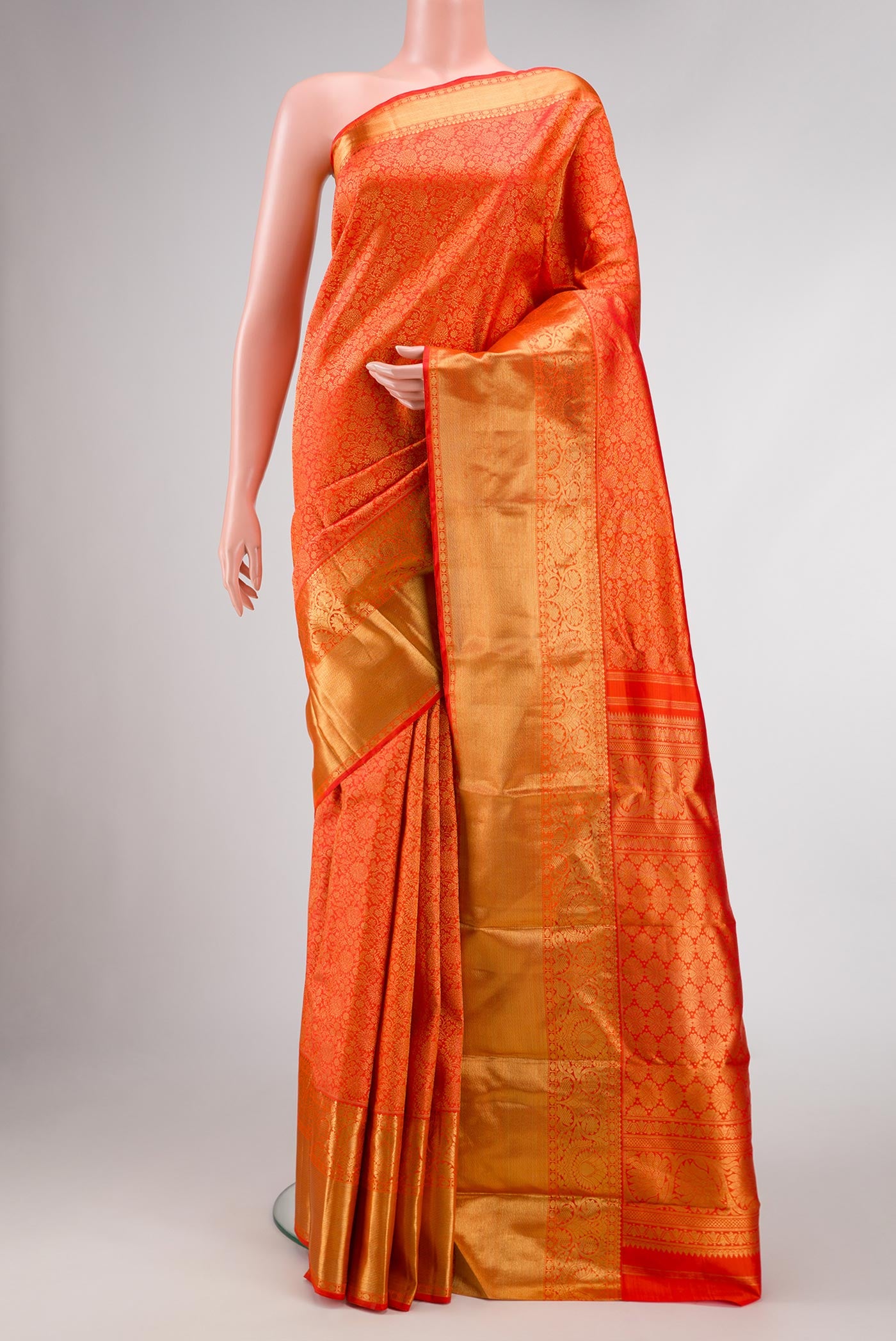 Pure Silk Pure Zari Orange Dual Tone Kanjivaram Saree with Zari Brocade on the body and Zari Border.  displayed on a mannequin