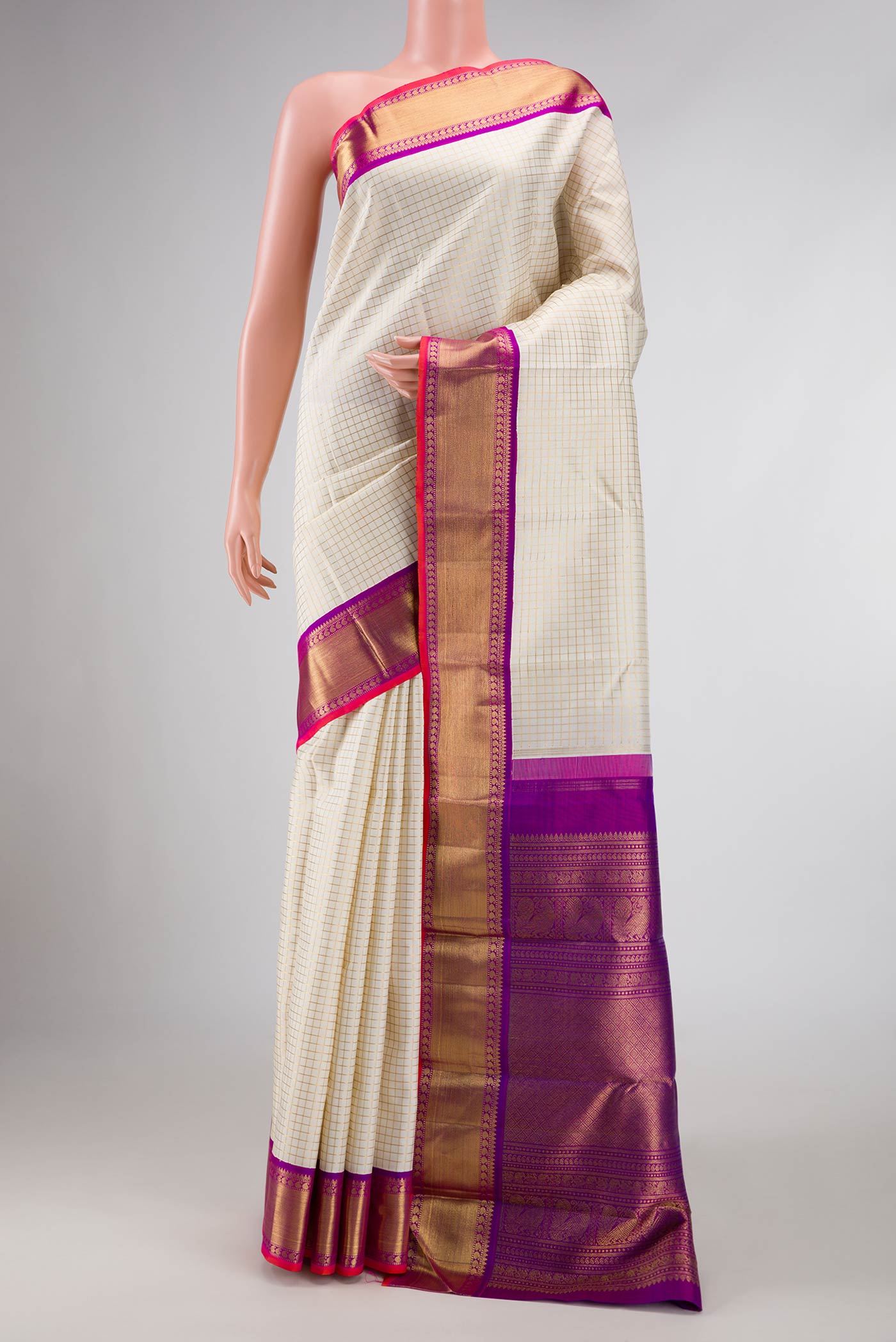 Pure Silk Pure Zari Off White Dual Tone Kanchipuram Saree with Checked design on the body and Zari Border displayed on a mannequin