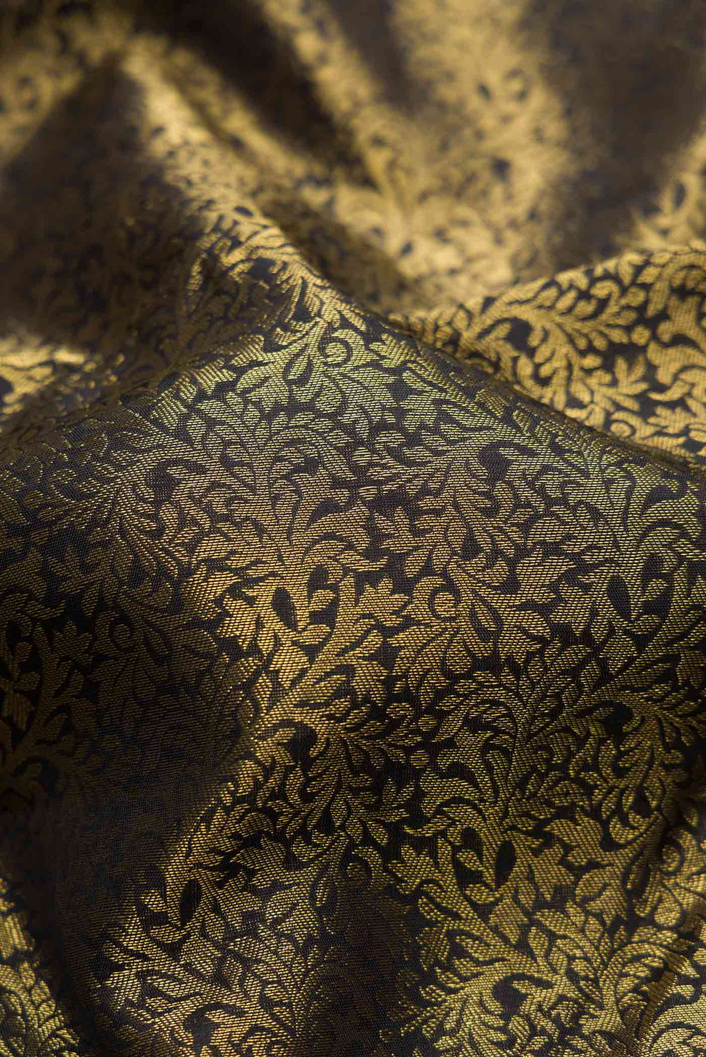 Close up of Pure Silk Pure Zari Black Dual Tone Kanjivaram Tissue Saree with Zari Brocade on the body and Zari Border.  displaying folds
