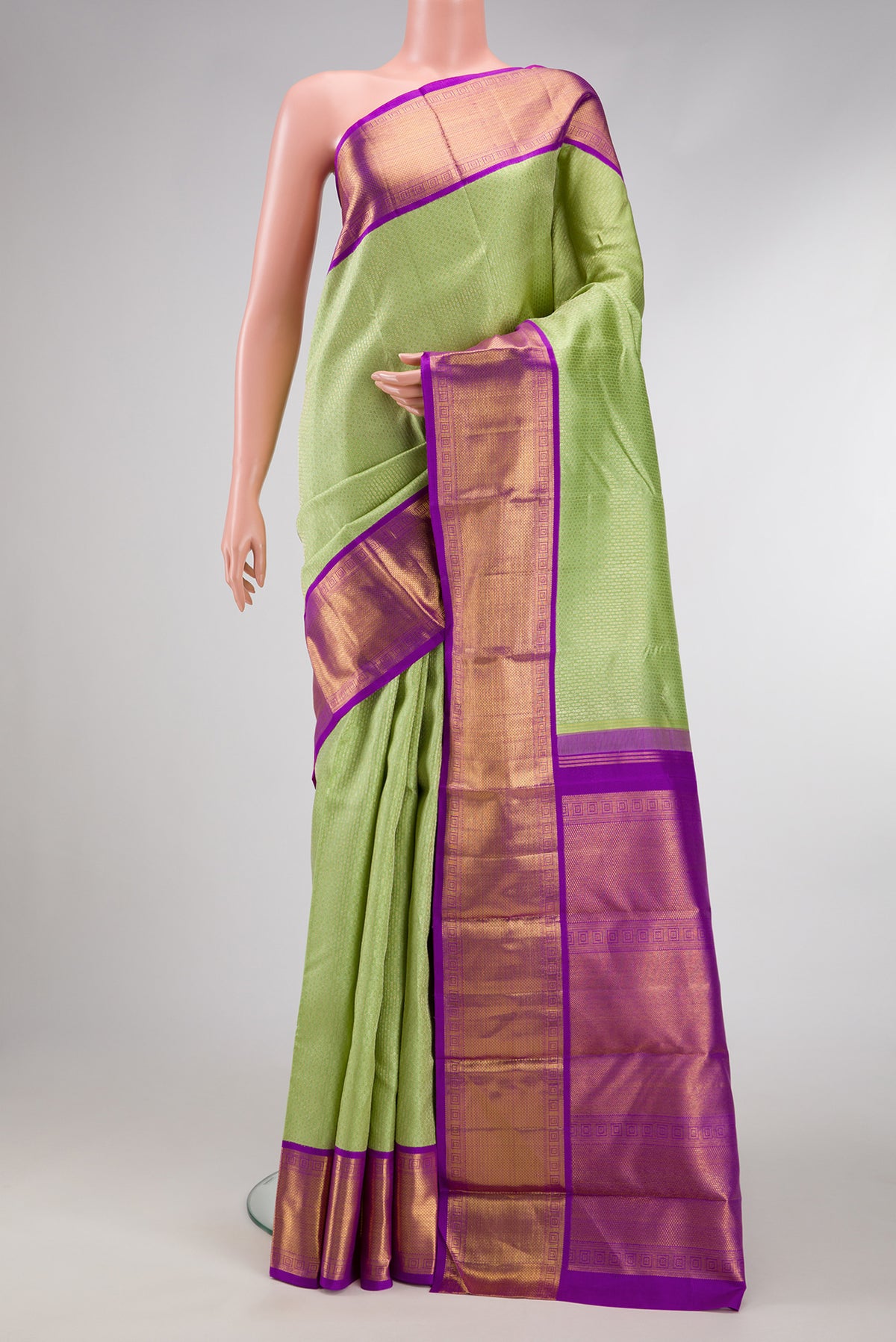 Pista Green Dual Tone Kanjivaram Silk Saree with Zari Brocade on the body and Zari Border.  displayed on a mannequin