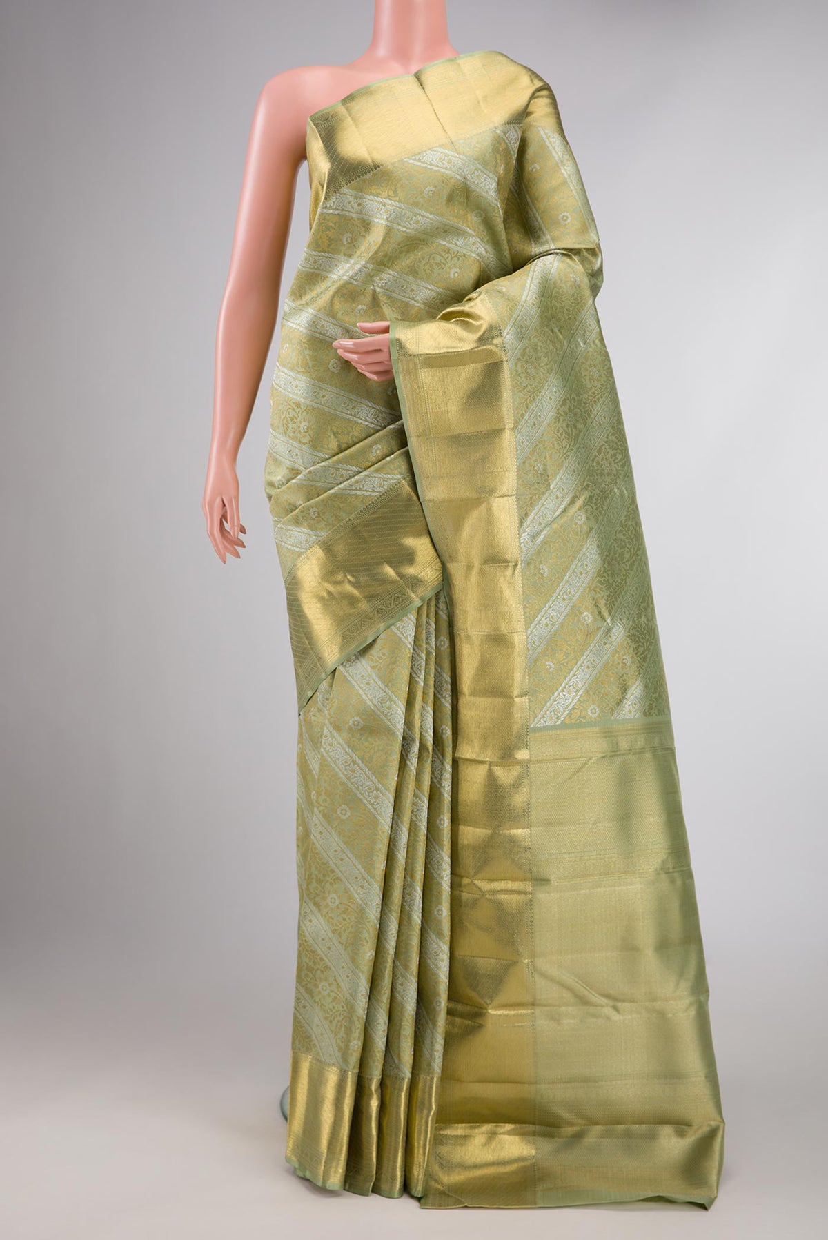 Pista Green Dual Tone Kanchipuram Silk Saree with Zari Brocade on the body and Zari Border displayed on a mannequin