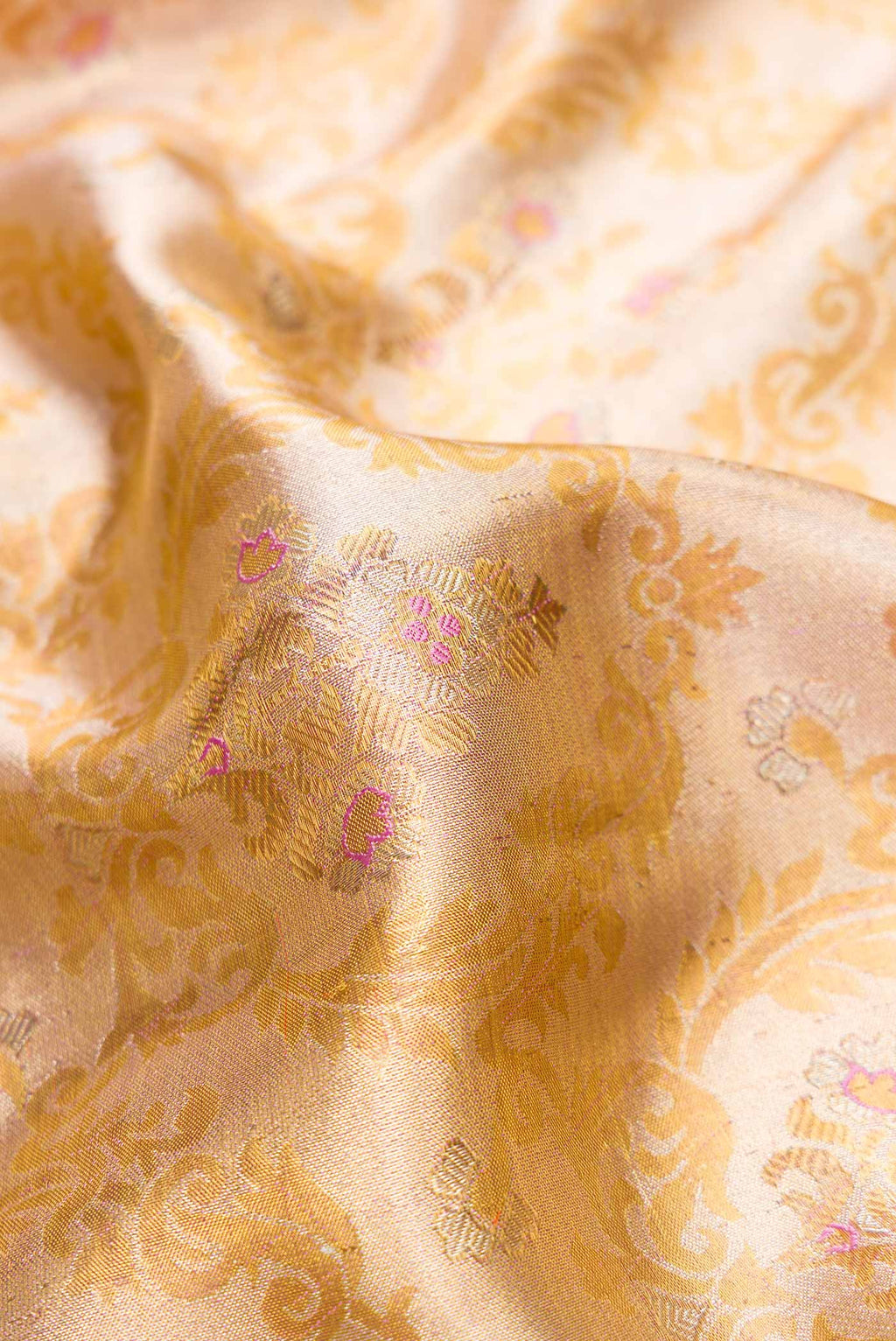 Close up of Gold Dual Tone Kanjivaram Tissue Silk Saree with Zari Brocade on the body and Zari Border.  displaying folds