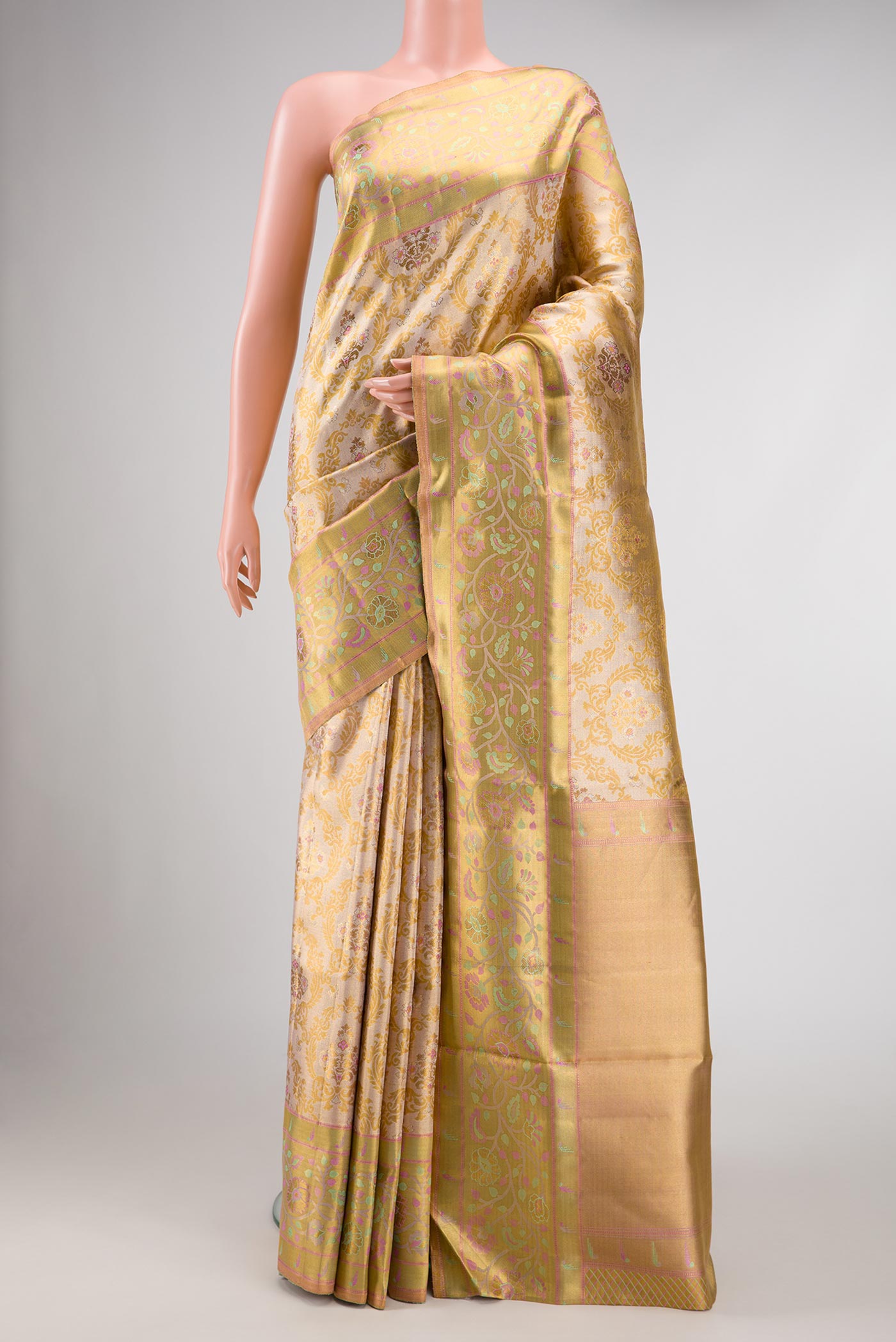 Gold Dual Tone Kanjivaram Tissue Silk Saree with Zari Brocade on the body and Zari Border.  displayed on a mannequin