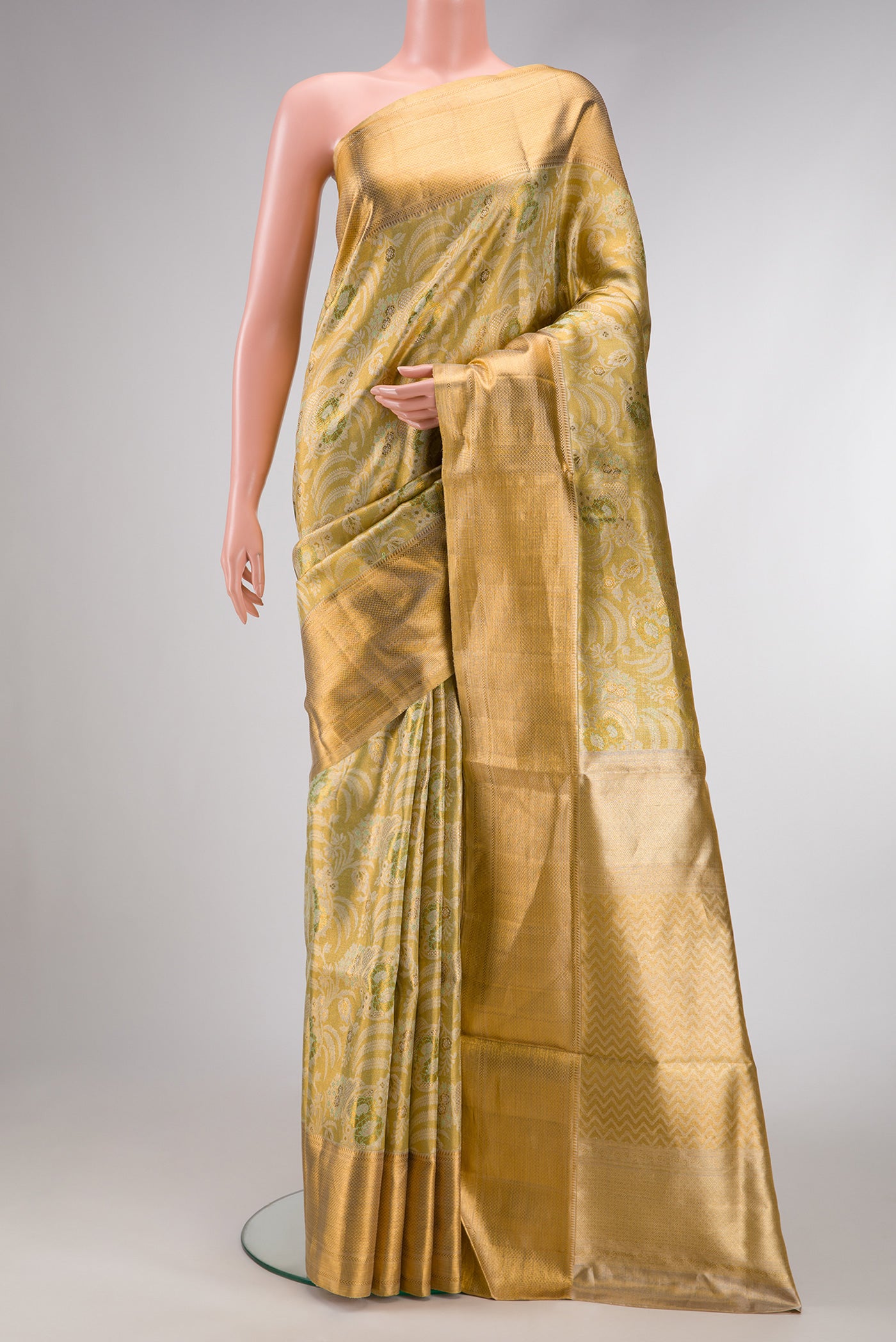 Pista Green Dual Tone Kanjivaram Tissue Silk Saree with Zari Brocade on the body and Zari Border.  displayed on a mannequin