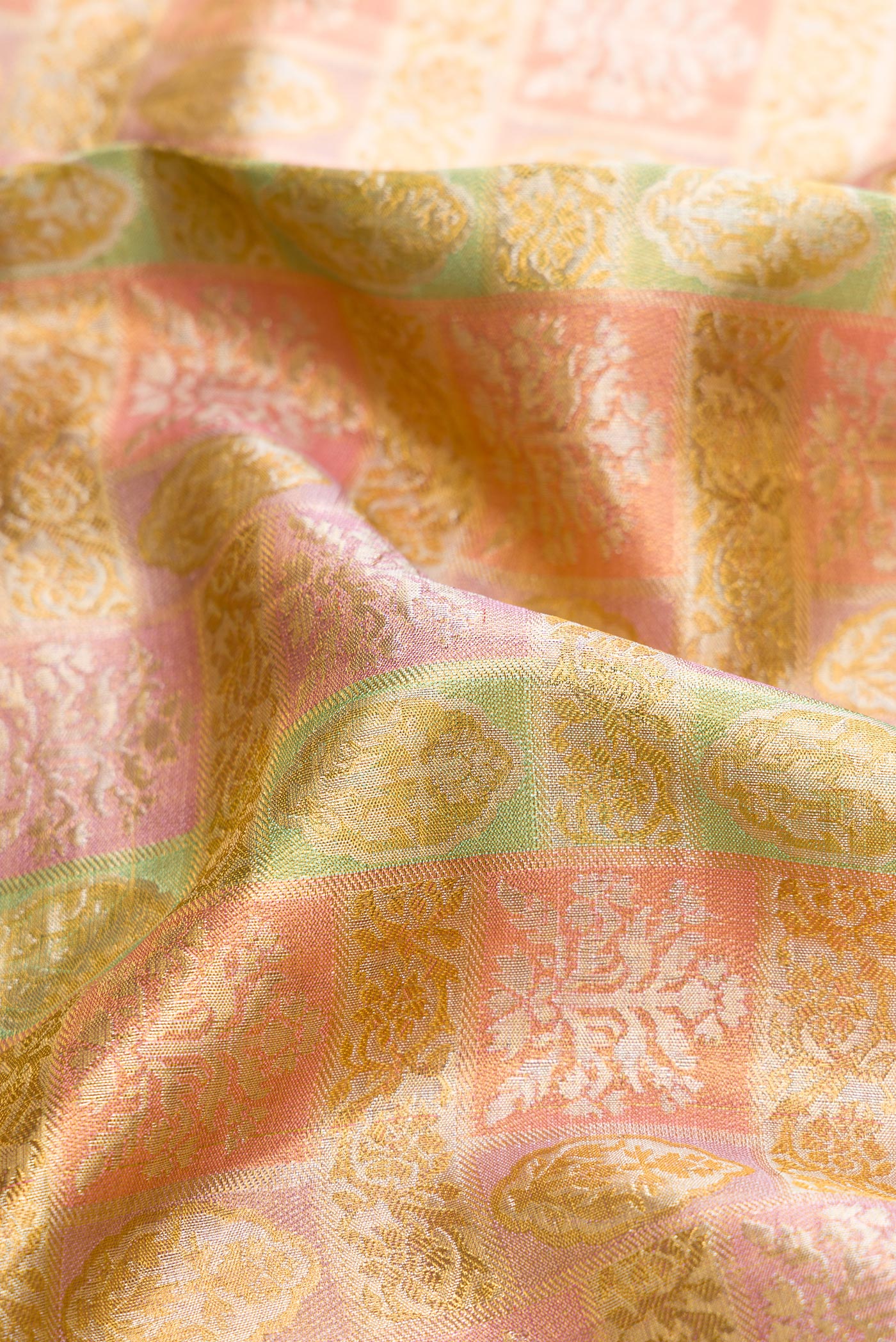 Close up of Pista Green Dual Tone Kanjivaram Tissue Silk Saree with Zari Brocade on the body and Zari Border.  displaying folds