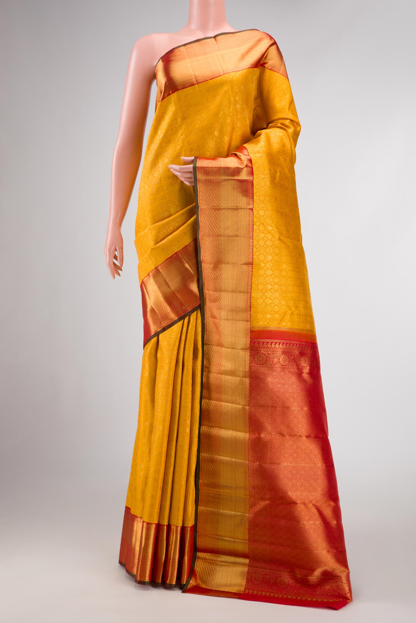 Pure Silk Pure Zari Mustard Dual Tone Kanchipuram Saree with Zari Brocade on the body and Zari Border displayed on a mannequin