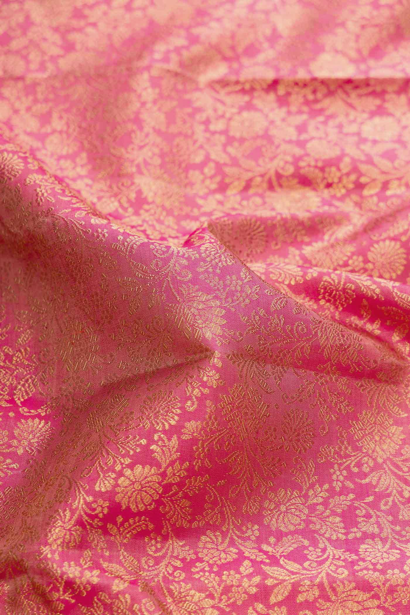 Close up of Pure Silk Pure Zari Pink Dual Tone Kanchipuram Saree with Zari Brocade on the body and Zari Border displaying folds