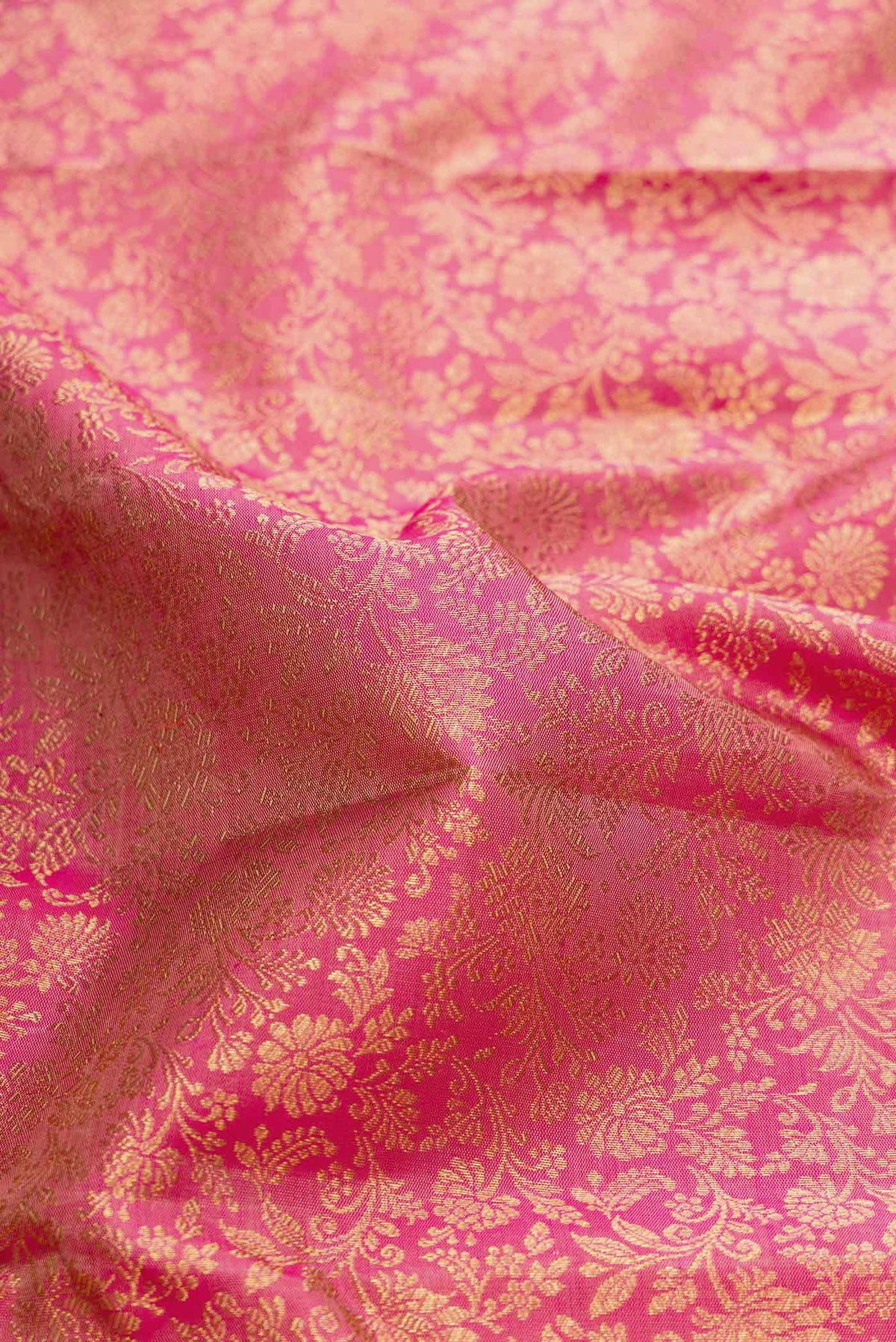 Close up of Pure Silk Pure Zari Pink Dual Tone Kanchipuram Saree with Zari Brocade on the body and Zari Border displaying folds
