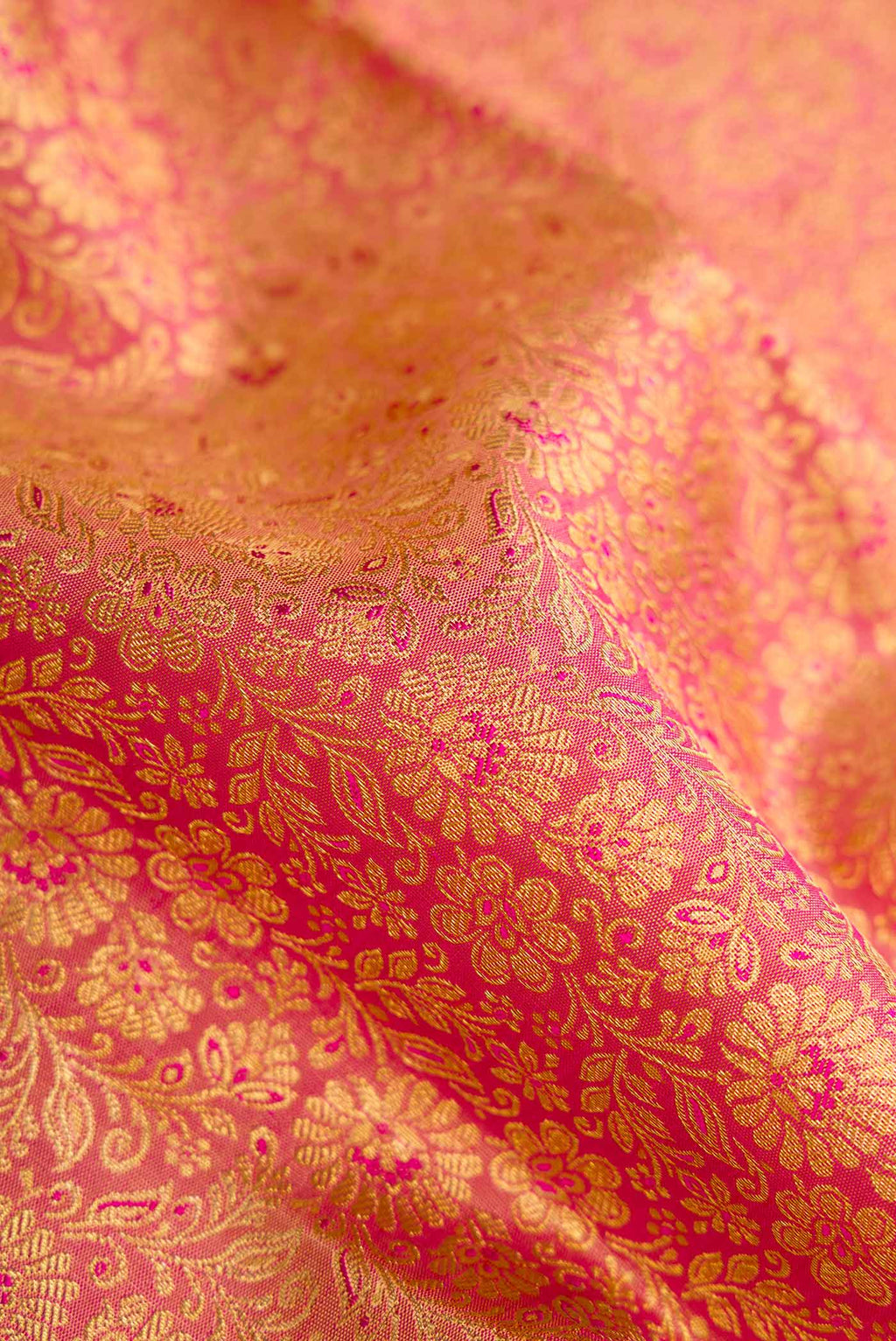 Close up of Pure Silk Pure Zari Coral Kanchipuram Saree with Zari Brocade on the body and Zari Border displaying folds