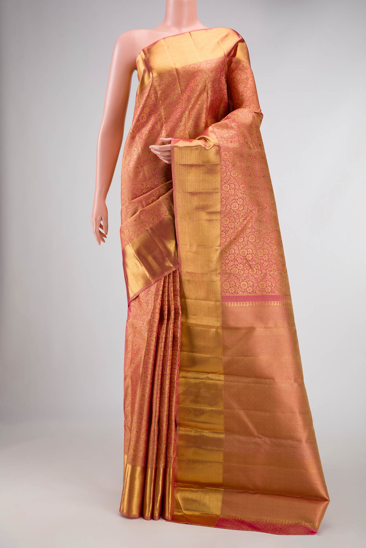 Pure Silk Pure Zari Coral Kanchipuram Saree with Zari Brocade on the body and Zari Border displayed on a mannequin