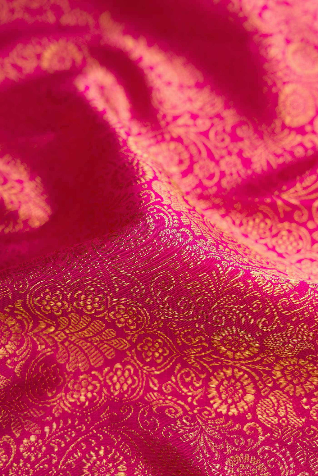 Close up of Pure Silk Pure Zari Pink Dual Tone Kanchipuram Saree with Zari Brocade on the body and Zari Border displaying folds