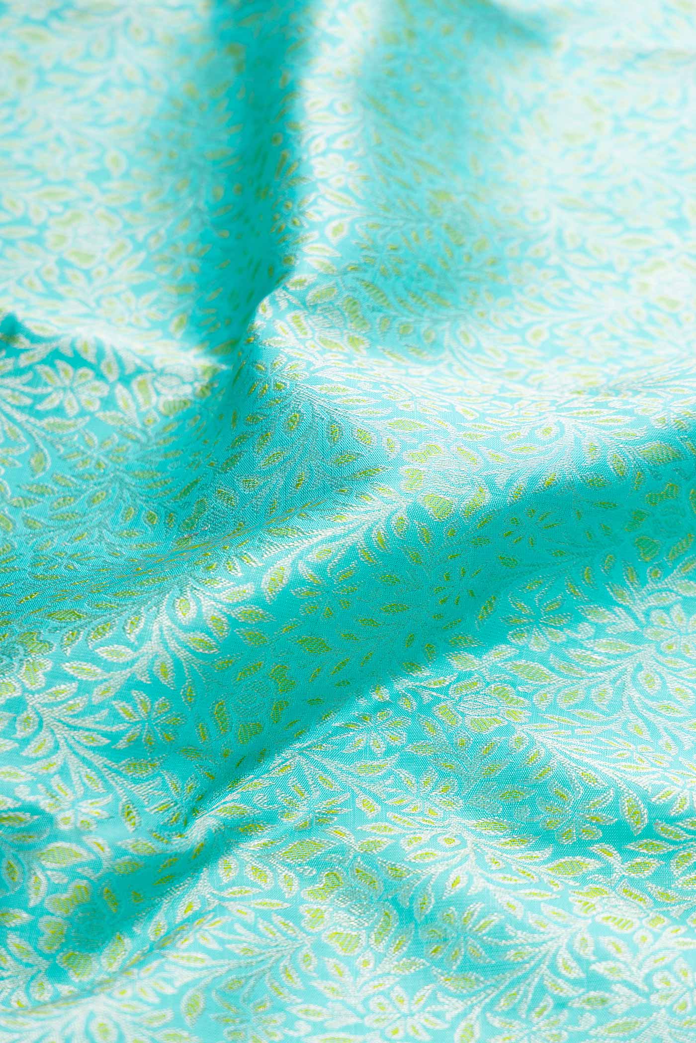 Close up of Pure Silk Pure Zari Sky Blue Dual Tone Kanchipuram Saree with Zari Brocade on the body and Zari Border displaying folds