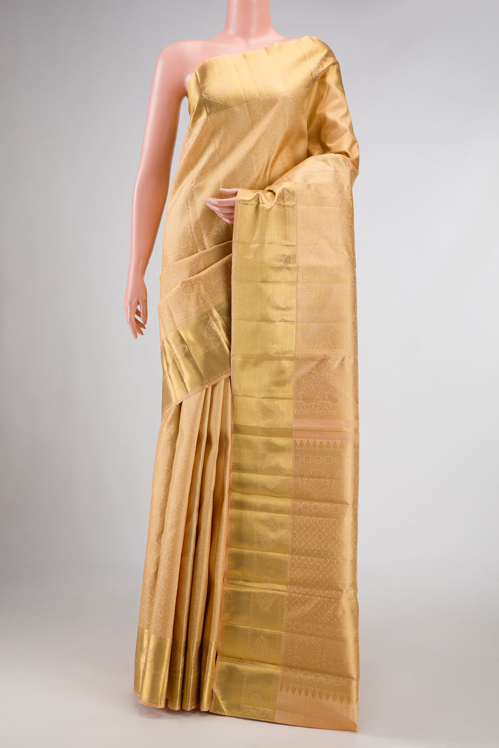 Pure Silk Pure Zari Golden Peach Dual Tone Kanchipuram Saree with Zari Brocade on the body and Zari Border displayed on a mannequin