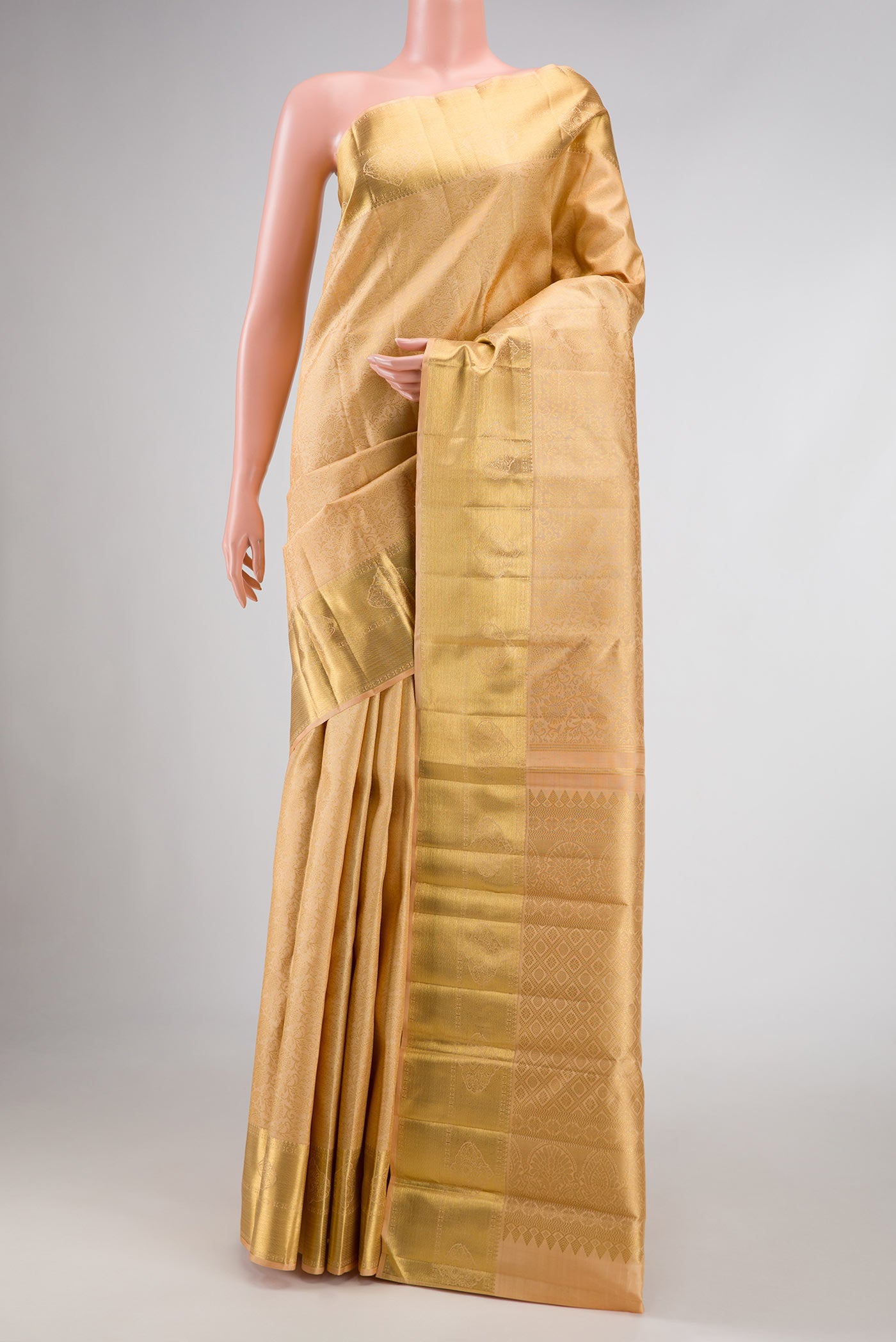Pure Silk Pure Zari Golden Peach Dual Tone Kanchipuram Saree with Zari Brocade on the body and Zari Border displayed on a mannequin