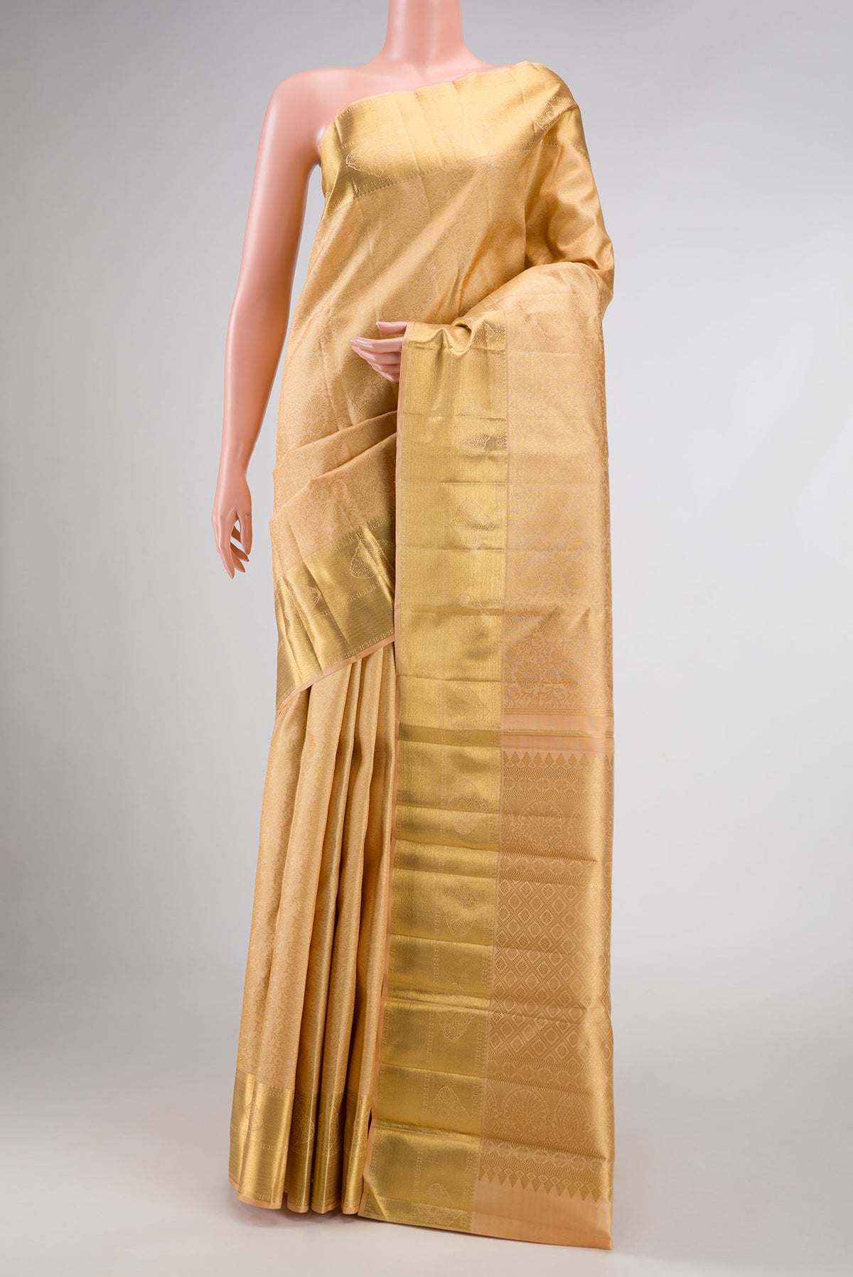Pure Silk Pure Zari Golden Peach Dual Tone Kanchipuram Saree with Zari Brocade on the body and Zari Border displayed on a mannequin