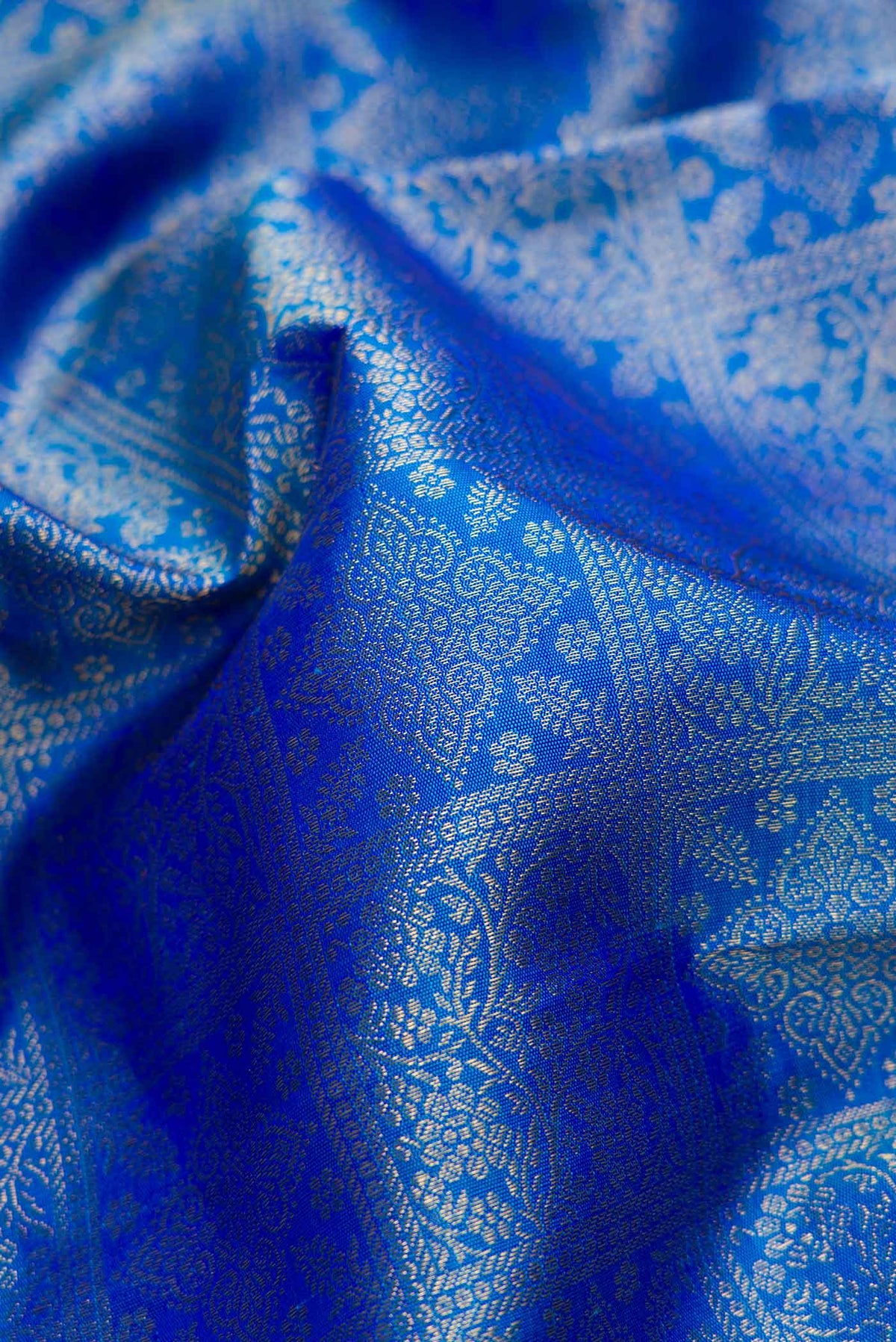 Close up of Pure Silk Pure Zari Peacock Blue Dual Tone Kanchipuram Saree with Zari Brocade on the body and Zari Border displaying folds