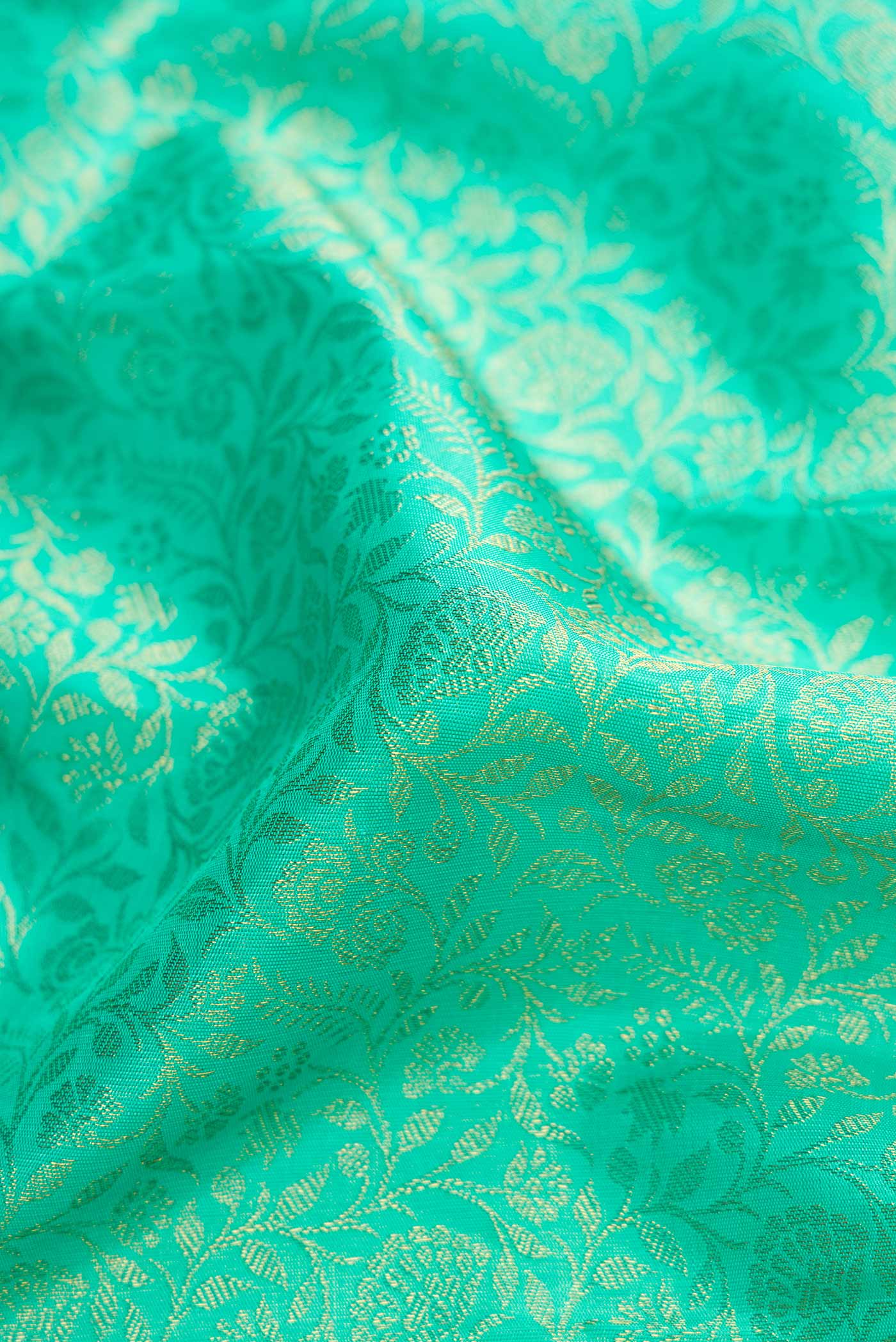 Close up of Pure Silk Pure Zari Sea Green Dual Tone Kanchipuram Saree with Zari Brocade on the body and Zari Border displaying folds