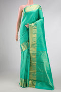 Pure Silk Pure Zari Sea Green Dual Tone Kanchipuram Saree with Zari Brocade on the body and Zari Border displayed on a mannequin