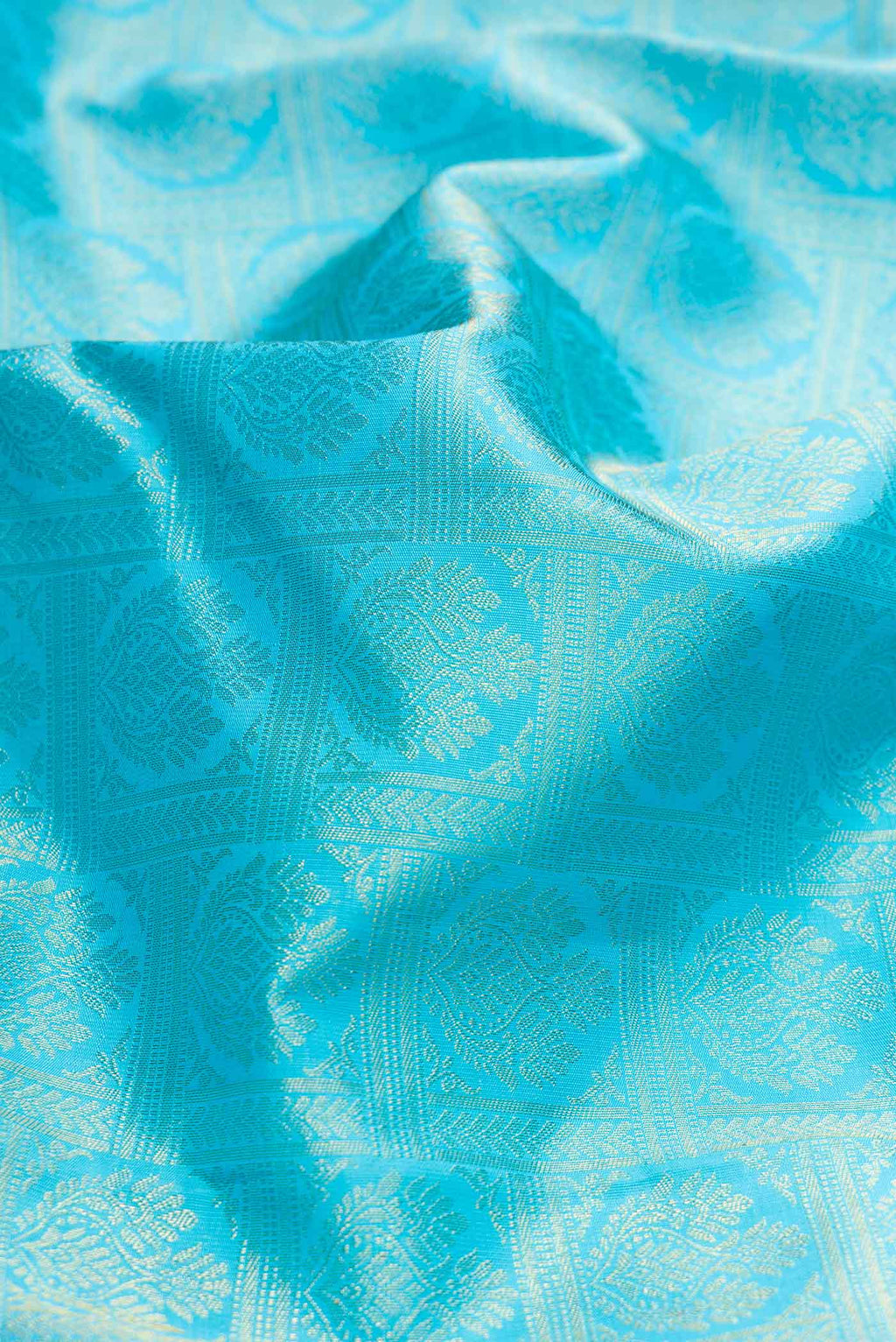 Close up of Pure Silk Pure Zari Sky Blue Dual Tone Kanchipuram Saree with Zari Brocade on the body and Zari Border displaying folds