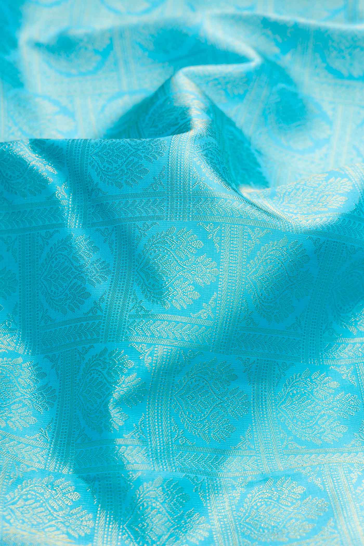 Close up of Pure Silk Pure Zari Sky Blue Dual Tone Kanchipuram Saree with Zari Brocade on the body and Zari Border displaying folds