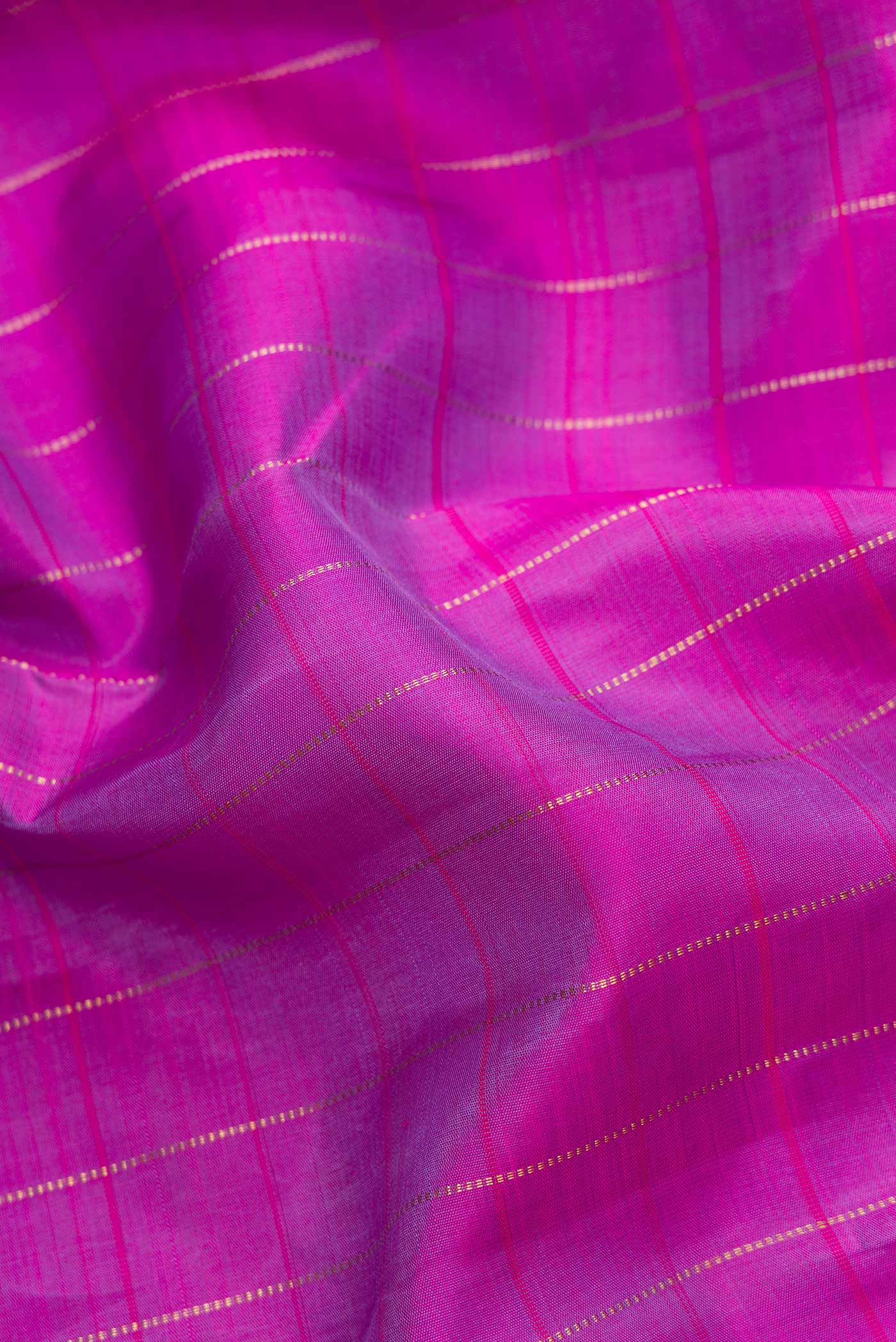 Close up of Purple Dual Tone Kanjivaram Silk Saree with Checked design on the body and Zari Border.  displaying folds