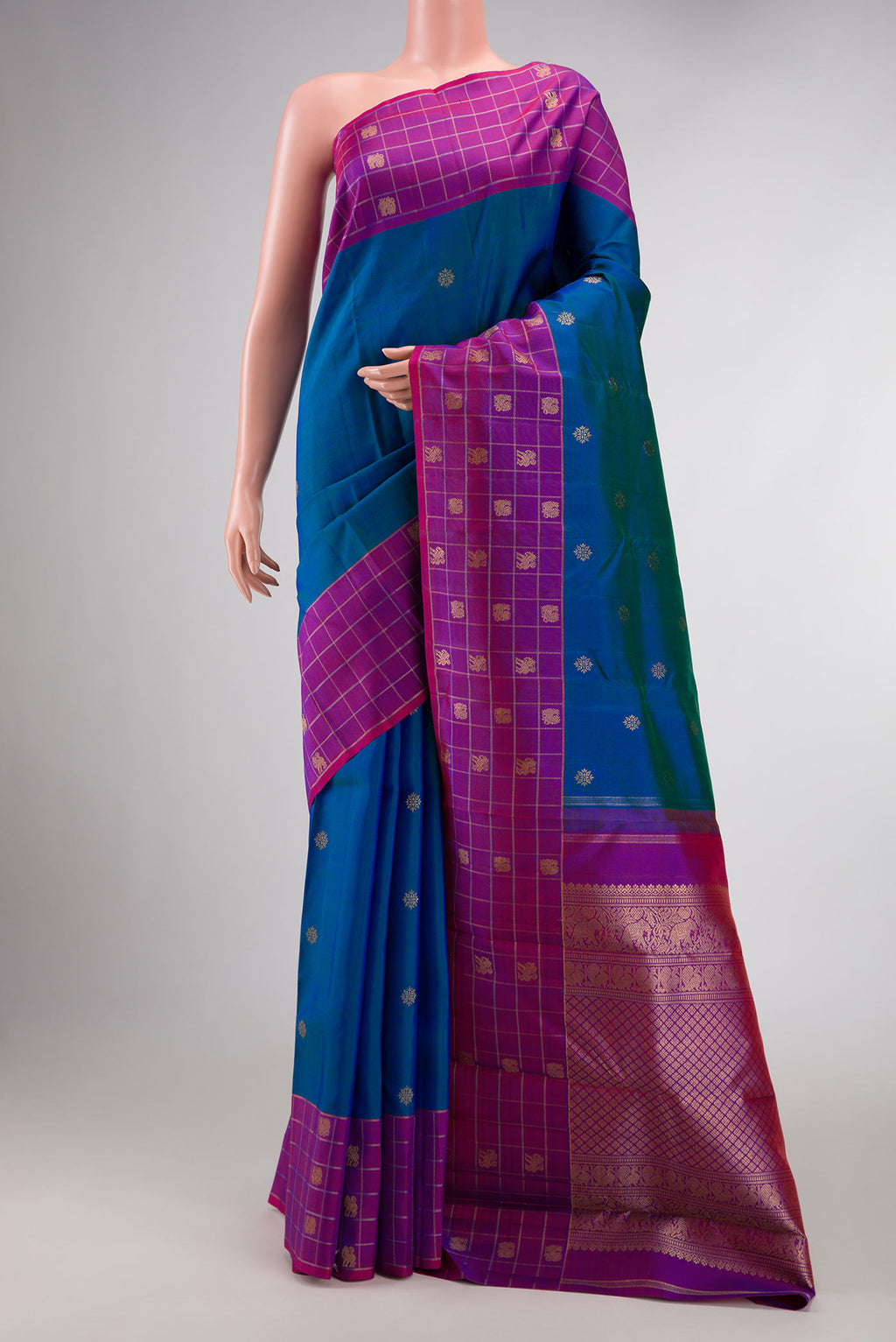 Pure Silk Pure Zari Peacock Blue Dual Tone Kanchipuram Saree with Zari Butta on the body and Zari Border displayed on a mannequin