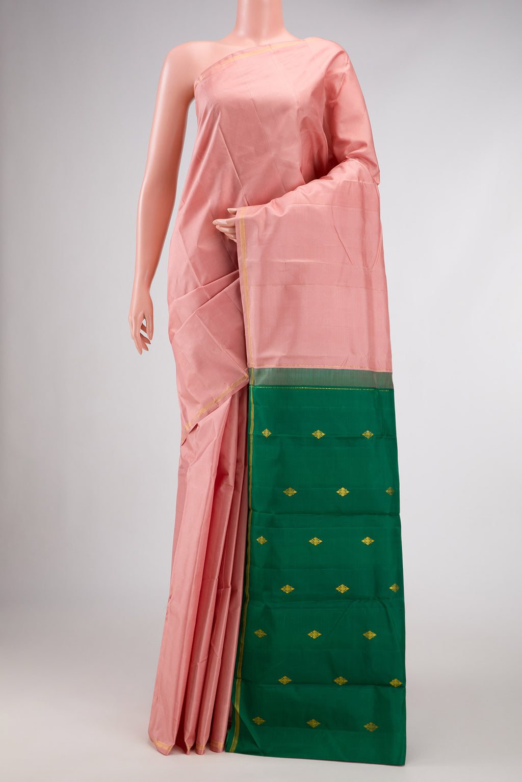 Rose Gold Dual Tone Kanchipuram Silk Saree with Plain Body and Thin Zari Line.  displayed on a mannequin