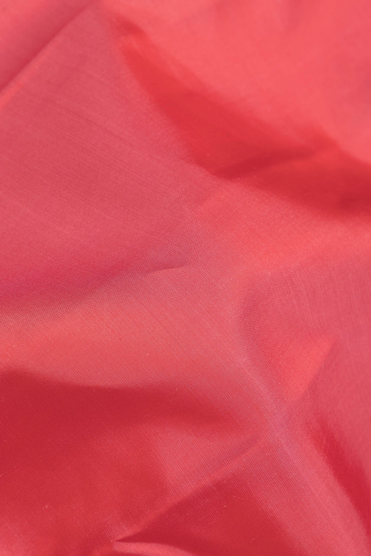 Close up of Pink Dual Tone Kanjivaram Silk Saree with Zari Butta on the body and Zari Border.  displaying folds