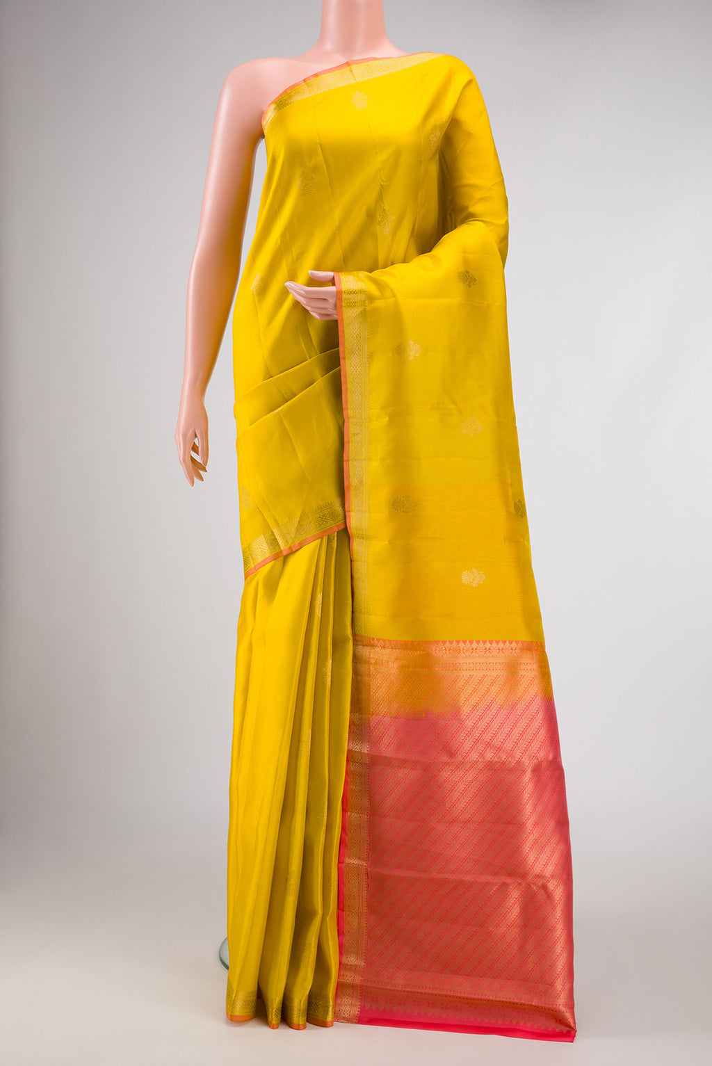 Yellow Dual Tone Kanchipuram Silk Saree with Zari Butta on the body and Zari Border displayed on a mannequin